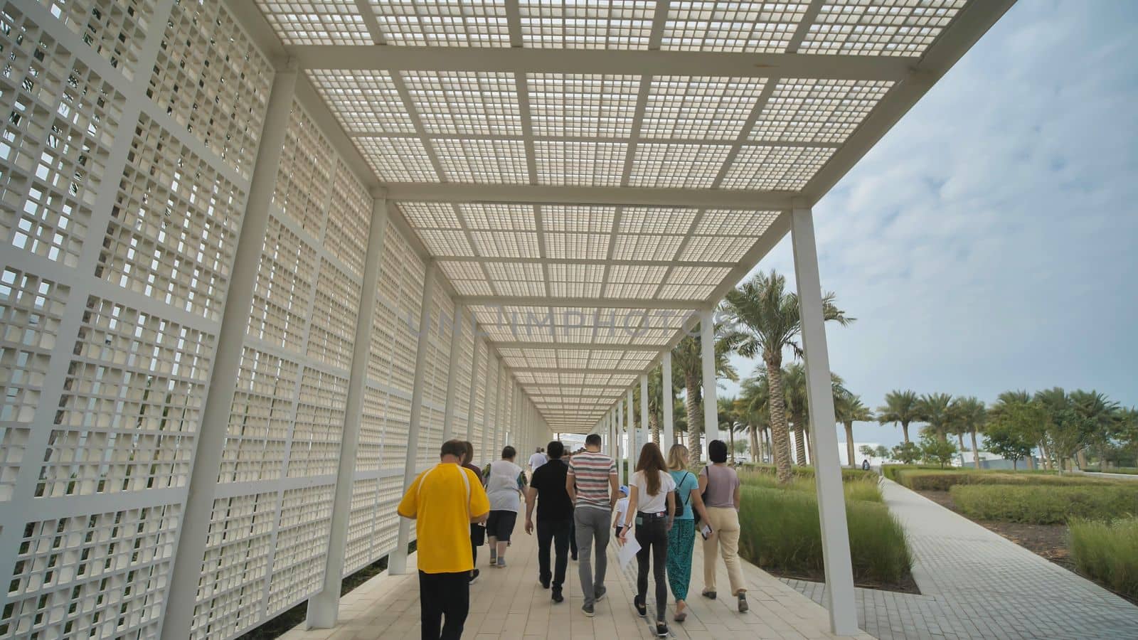 Tourists go to the Louvre Museum near Abu Dhabi.