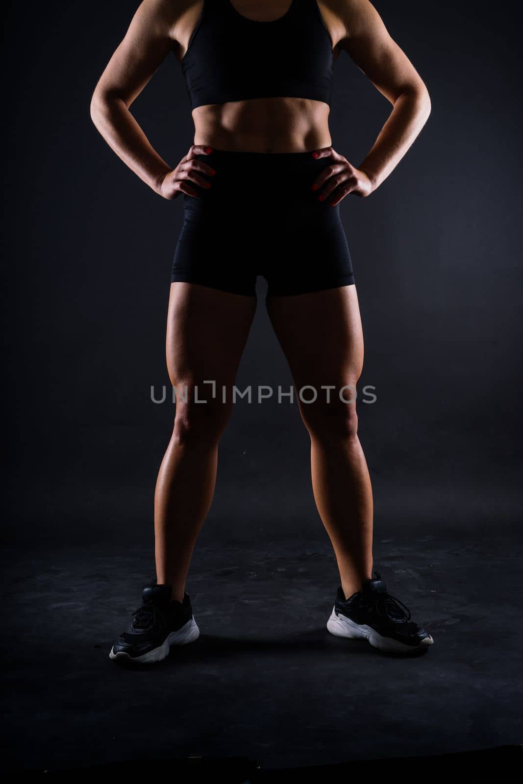 Strong sportswoman in boxing gloves prepared high kick. Isolated on a white, red, yellow background