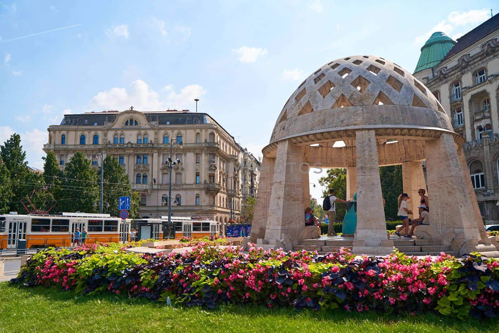 A flower bed on a green lawn on a street in Budapest by Try_my_best