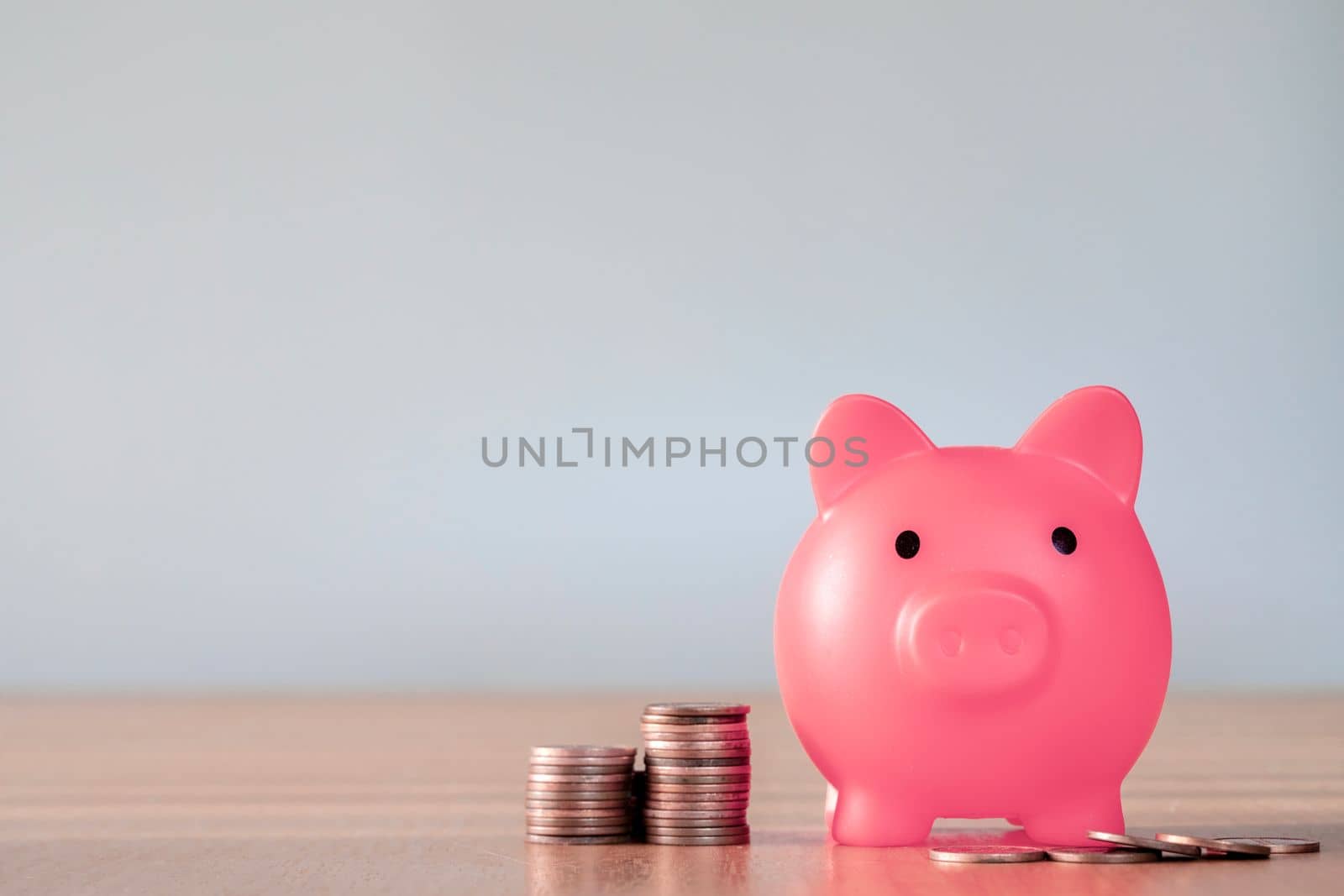 Piggy bank pink colour with money stack step up growing growth saving money, Concept financial business investment. Copy space for your text gray background close up