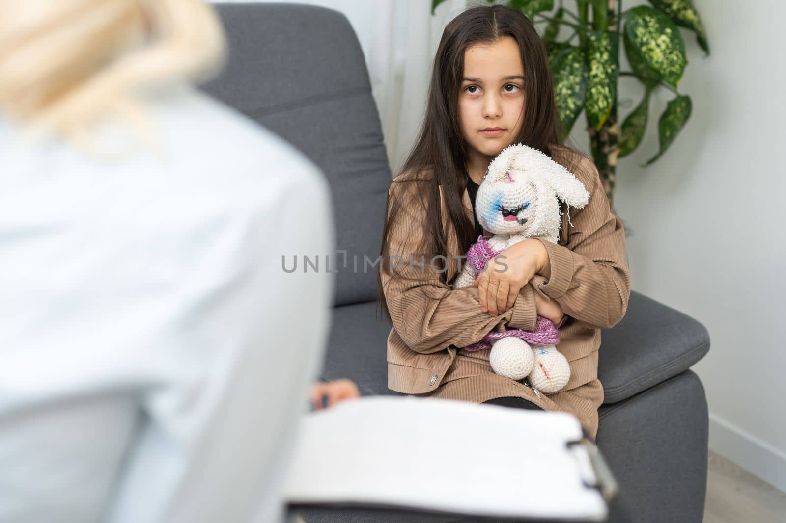 Young female psychologist talk with girl teenager. Caring woman social worker have meeting with teen schoolgirl.