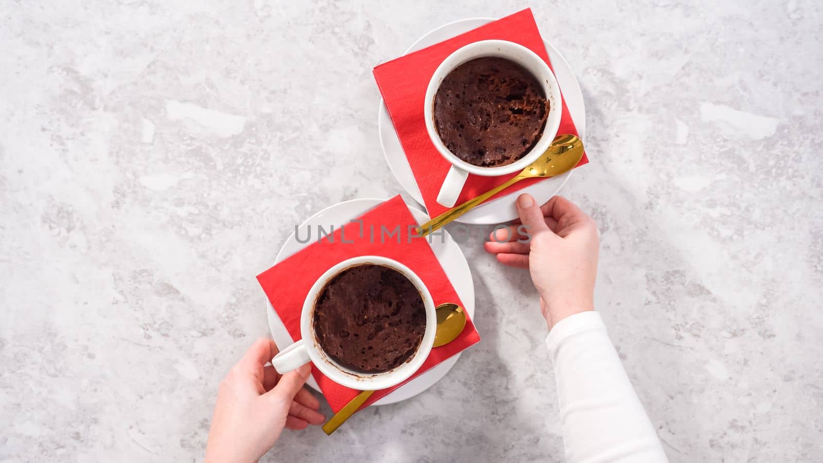 Flat lay. Step by step. Chocolate mug cakes garnished with whipped cream and chocolate hearts and lips.