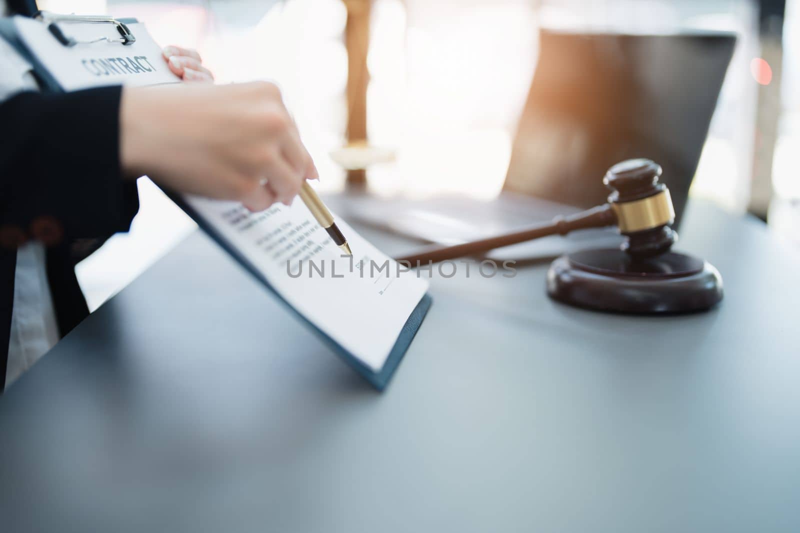 The lawyer with a client discussing contract paper, a Business lawyer working about legal legislation in the courtroom to help their customer, contract and agreement concept. by Manastrong