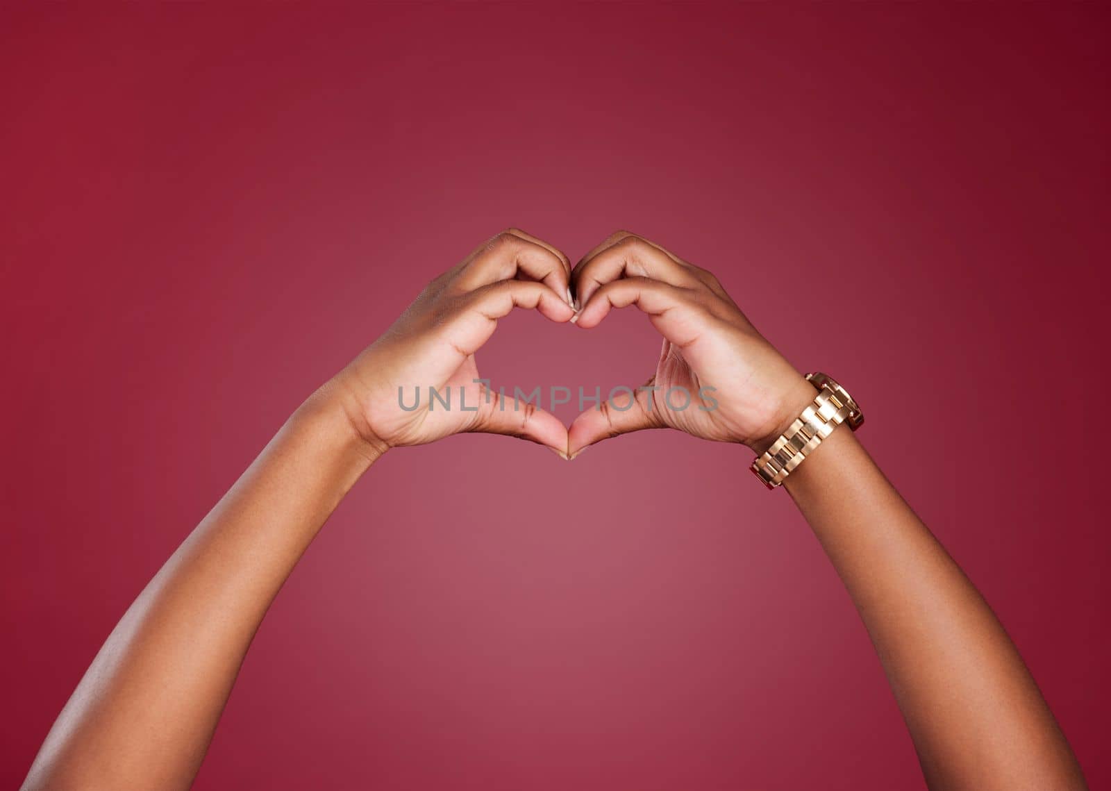 Hands, heart and sign for love, care or relationship in romance against a studio background. Hand in hearty emoji, shape or symbol for romantic gesture, valentines day or emotion on copy space by YuriArcurs