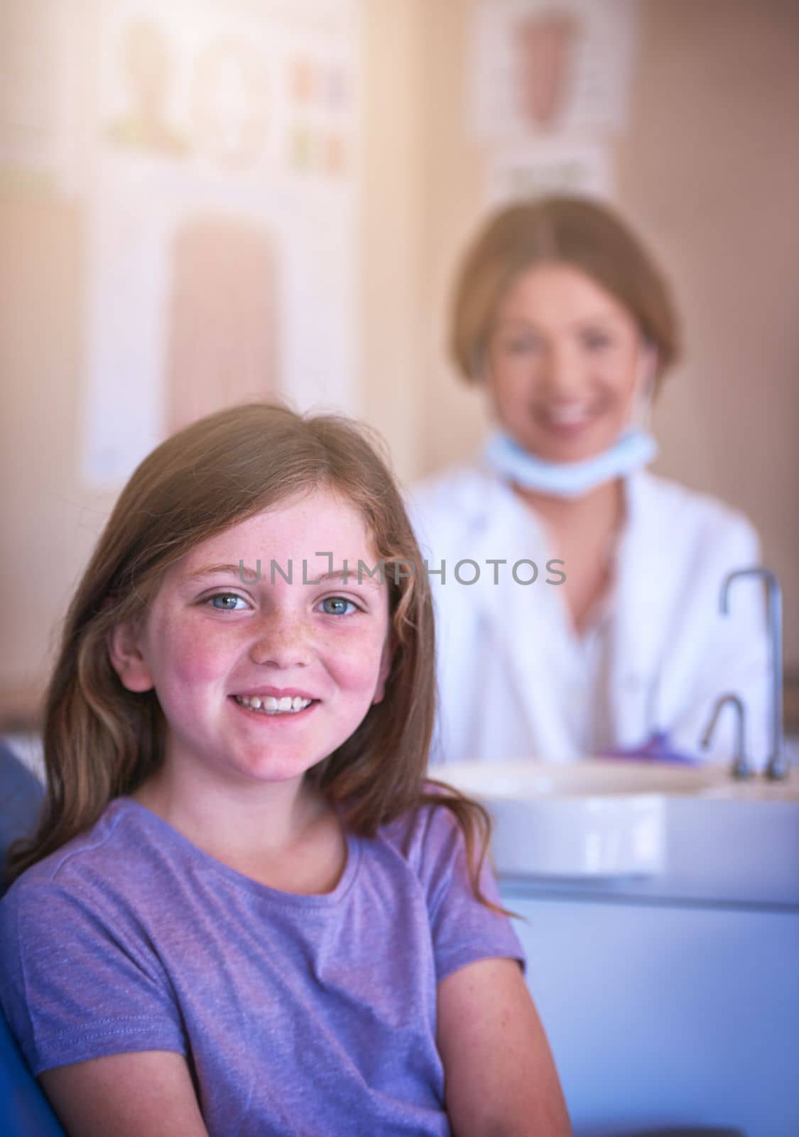 I enjoy my dentist visits, I dont need bribery. a little girl at the dentist for a checkup