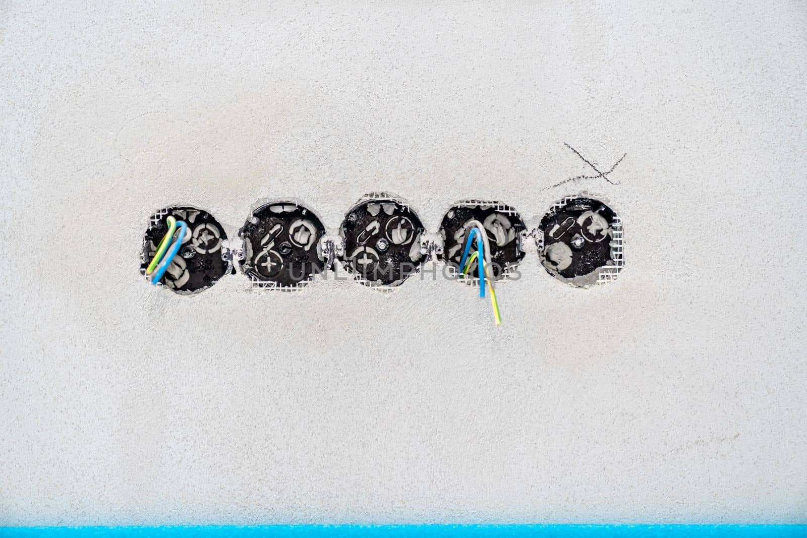 holes and wires in the wall for sockets and switches. High quality photo