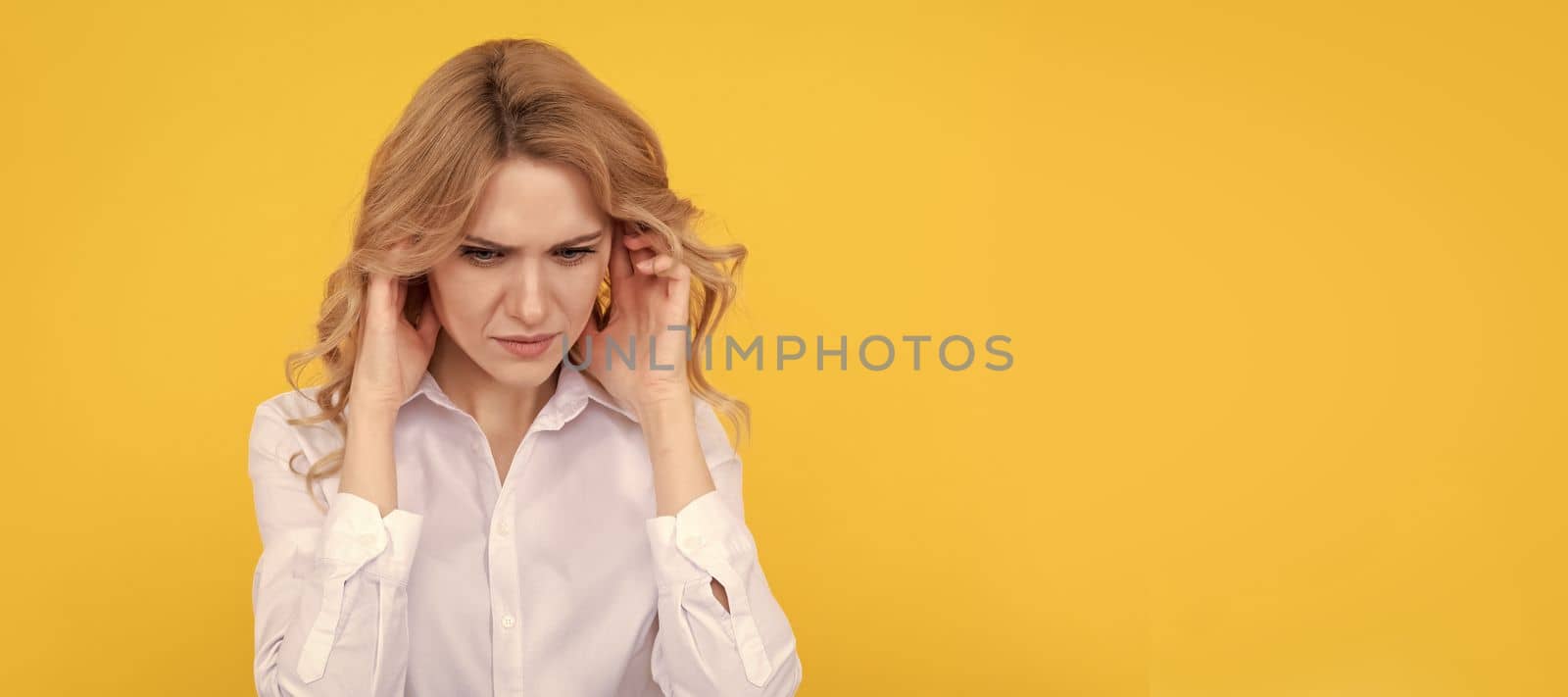 Woman isolated face portrait, banner with mock up copy space. It is painful. Unhappy girl has pain in ears. Suffering from earache. Ear pain. headache