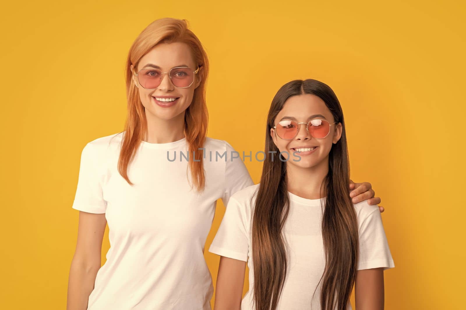 cheerful family portrait of single mom and child girl in glasses, eyewear.