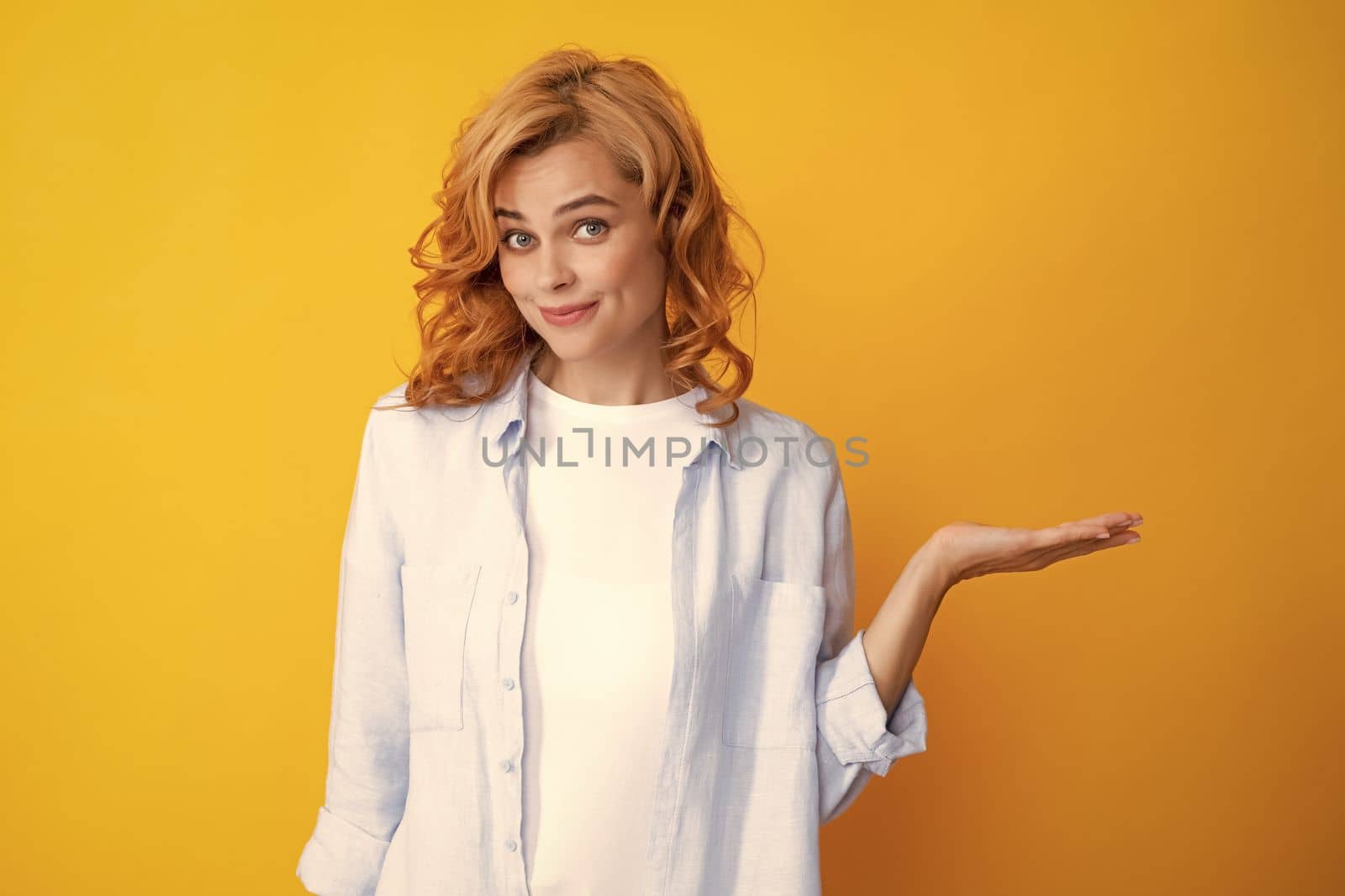 Woman point at copy space, showing copyspace pointing. Promo, girl showing advertisement content gesture, pointing with hand recommend product. Isolated background. by RedFoxStudio