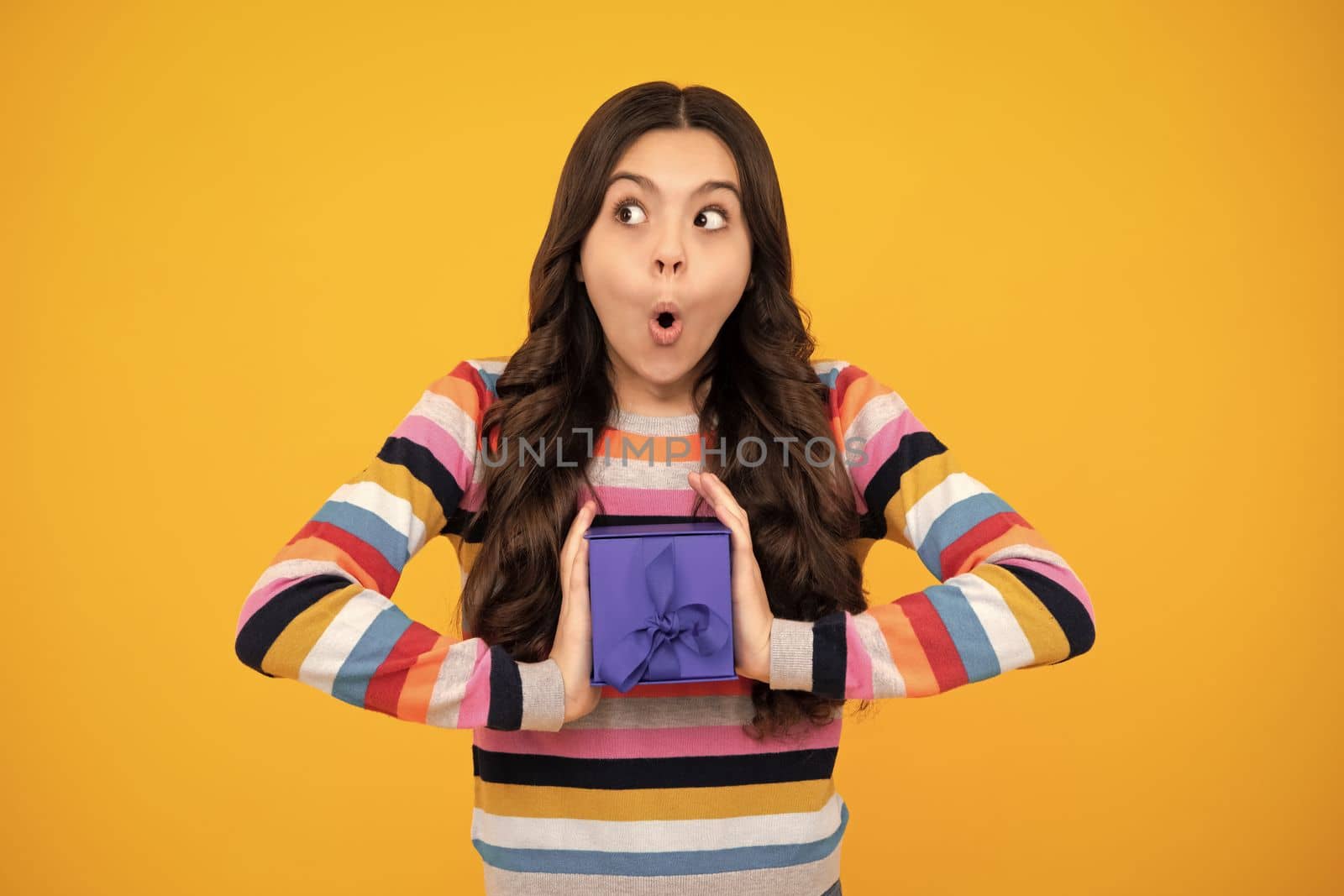 Shocked amazed face, surprised emotions of young teenager girl. Cute teenager child girl congratulate with valentines day, giving romantic gift box. Present, greeting and gifting concept