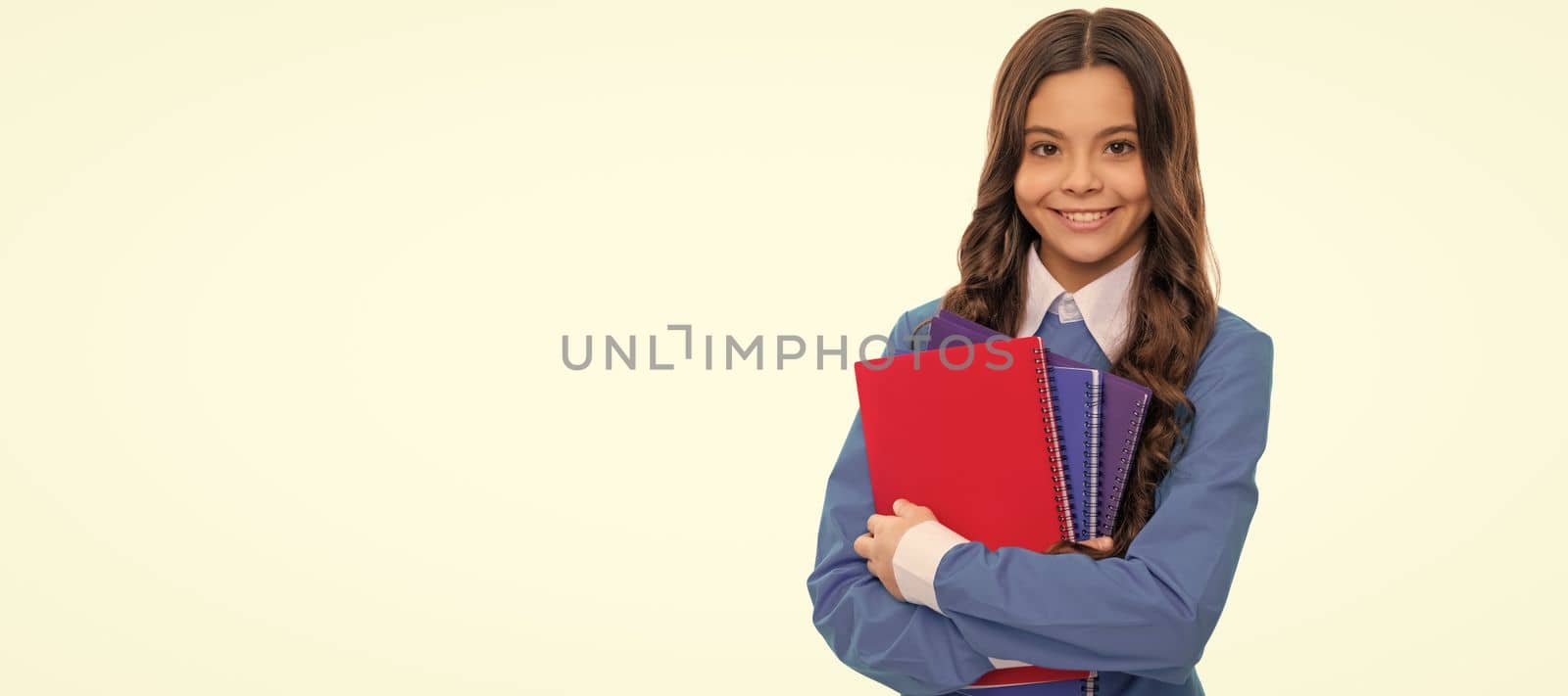 happy face of teen girl with long curly hair hold school workbook isolated on white, school. Banner of schoolgirl student. School child pupil portrait with copy space