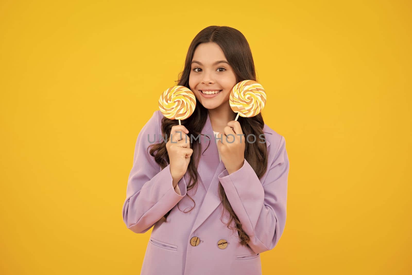 Teenage girl with lollipop, child eating sugar lollipops, kids sweets candy shop. Excited teenager girl. Happy teenager, positive and smiling emotions of teen girl. by RedFoxStudio