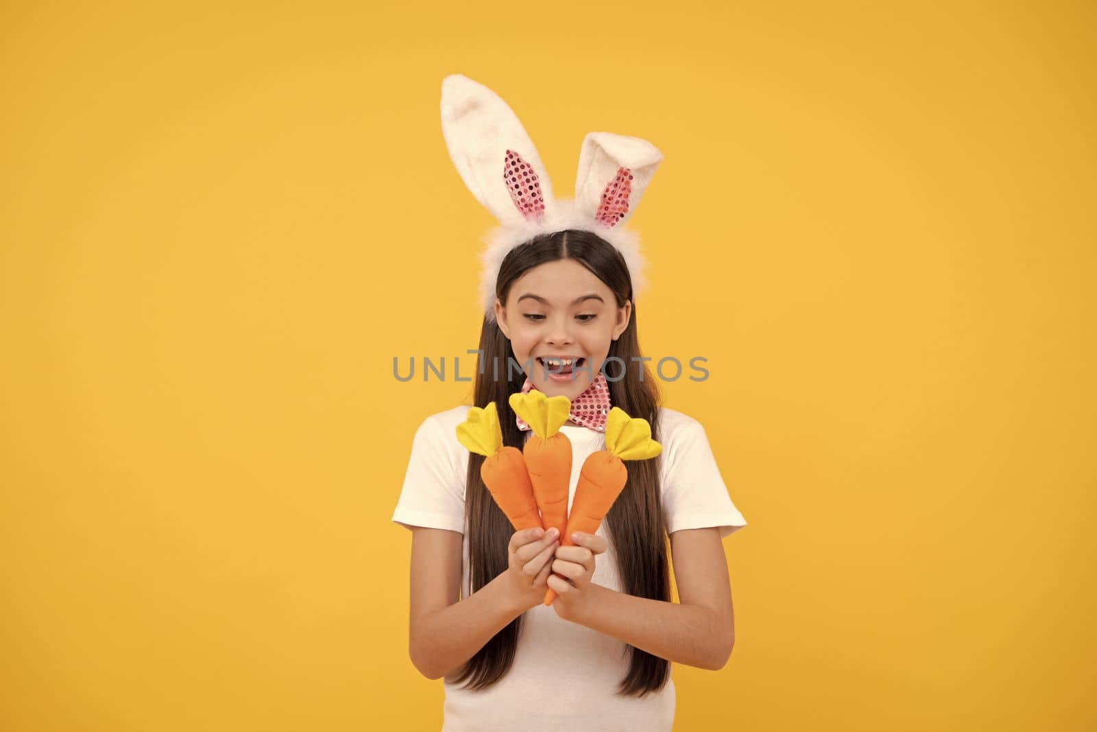 Easter time. just having fun. ready for party. happy childhood. cheerful bunny kid with carrot by RedFoxStudio