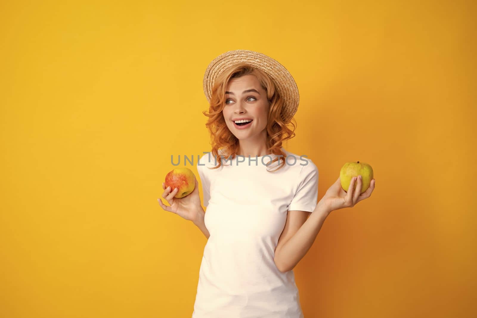 Beautiful smile of young woman holding apple. by RedFoxStudio