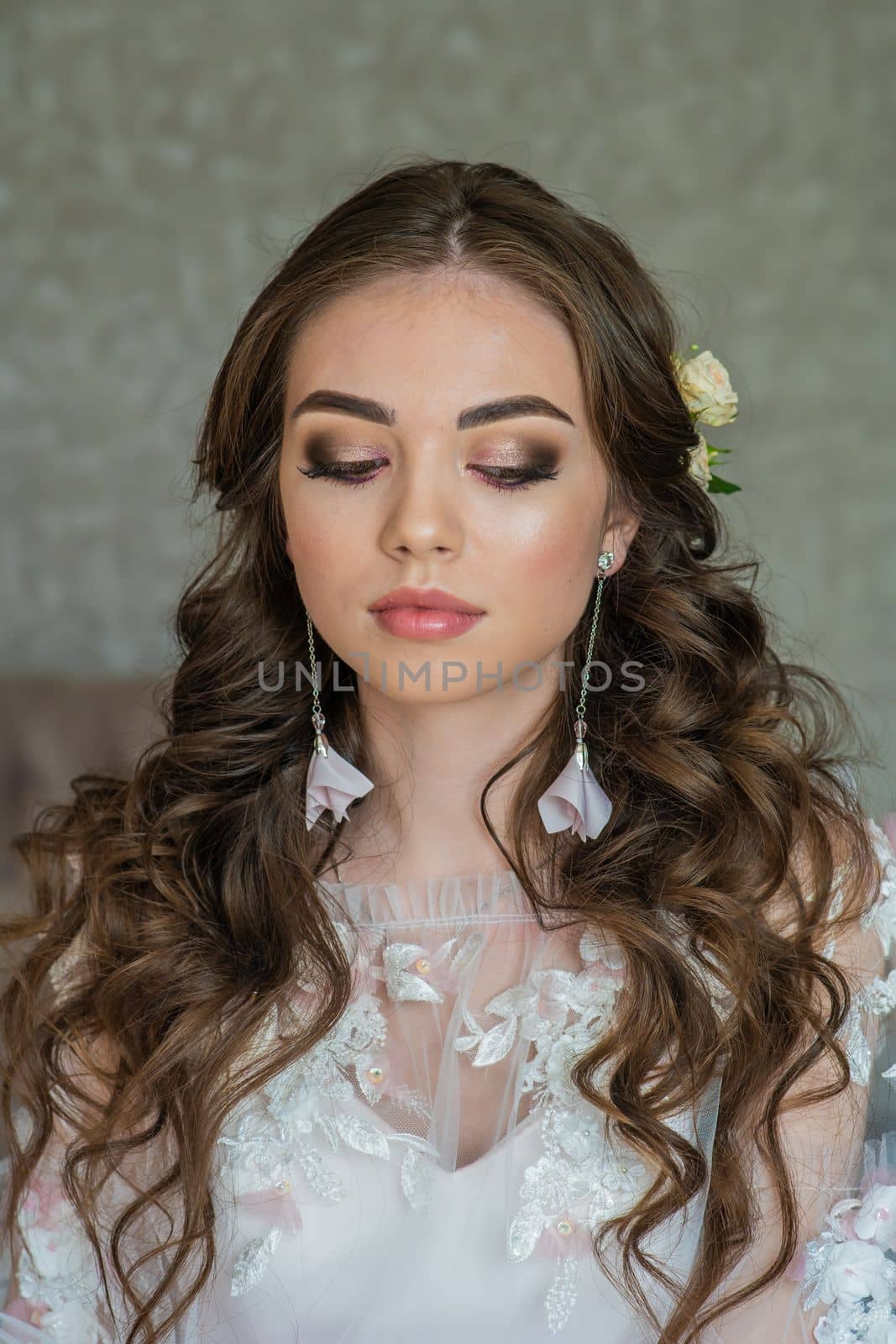 Beautiful festive make-up on a girl in a white dress. by DovidPro