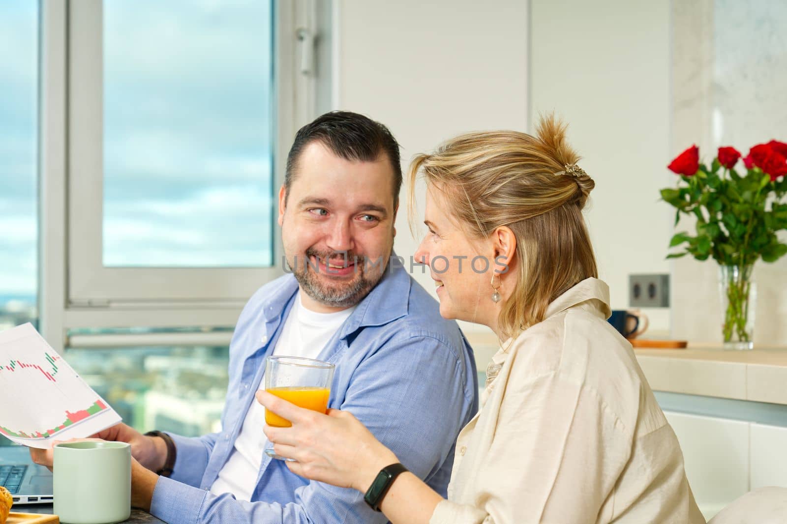 Young beautiful caucasian couple sitting at table while having breakfast at home Happy couple having breakfast together before leaving to work