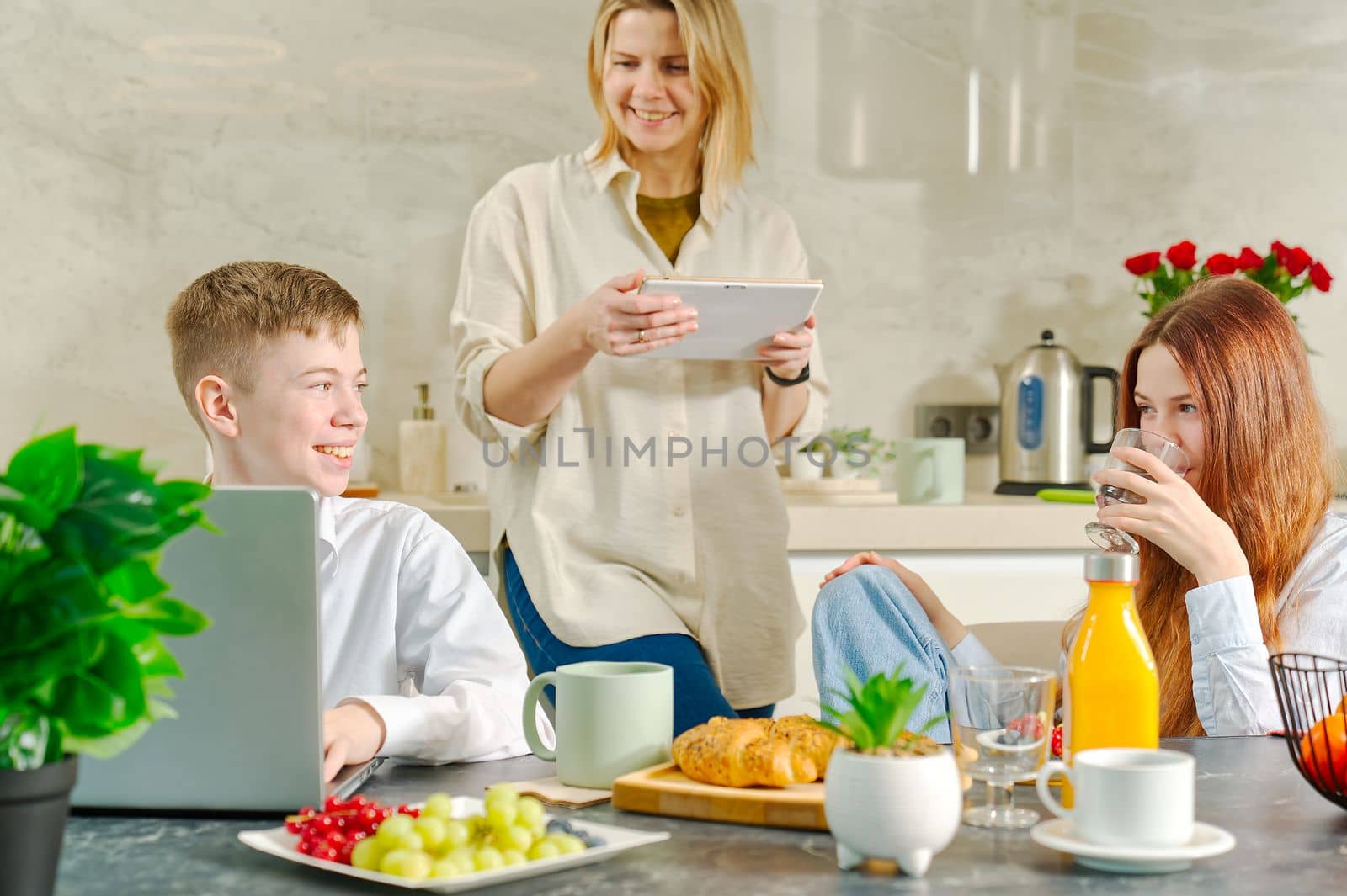 Young family with kids have fun at breakfast time. Happy family eating healthy breakfast together. by PhotoTime