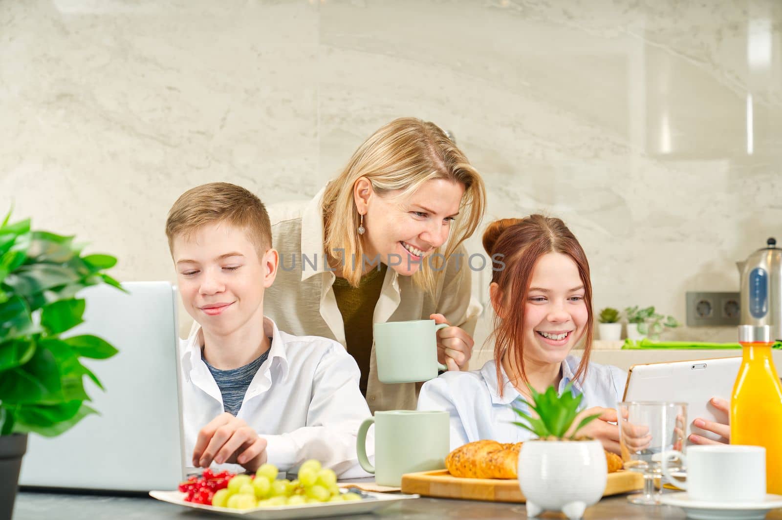 Young family with kids have fun at breakfast time. Happy family eating healthy breakfast together. by PhotoTime