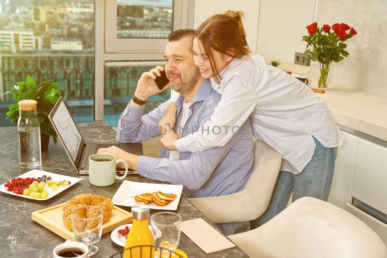 Happy father and daughter having breakfast in kitchen and using digital devices. Lifestyle, Morning breakfast, father and daughter together.