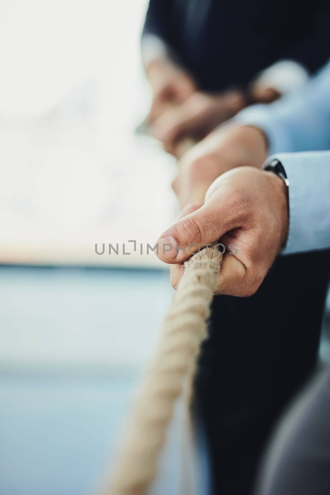 Only the determined will make it through. Closeup shot of unrecognizable businesspeople pulling on a rope