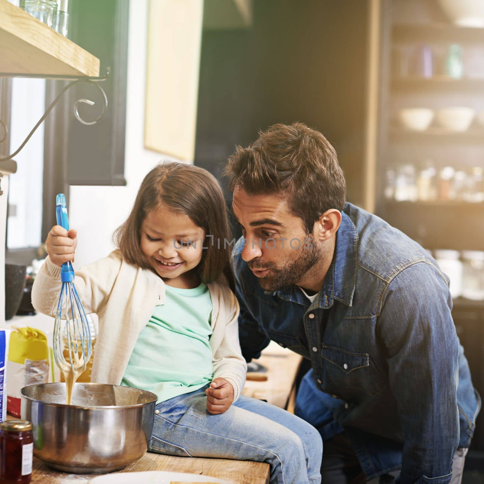 Nothing better than food, family and fun. a father and daughter making pancakes together