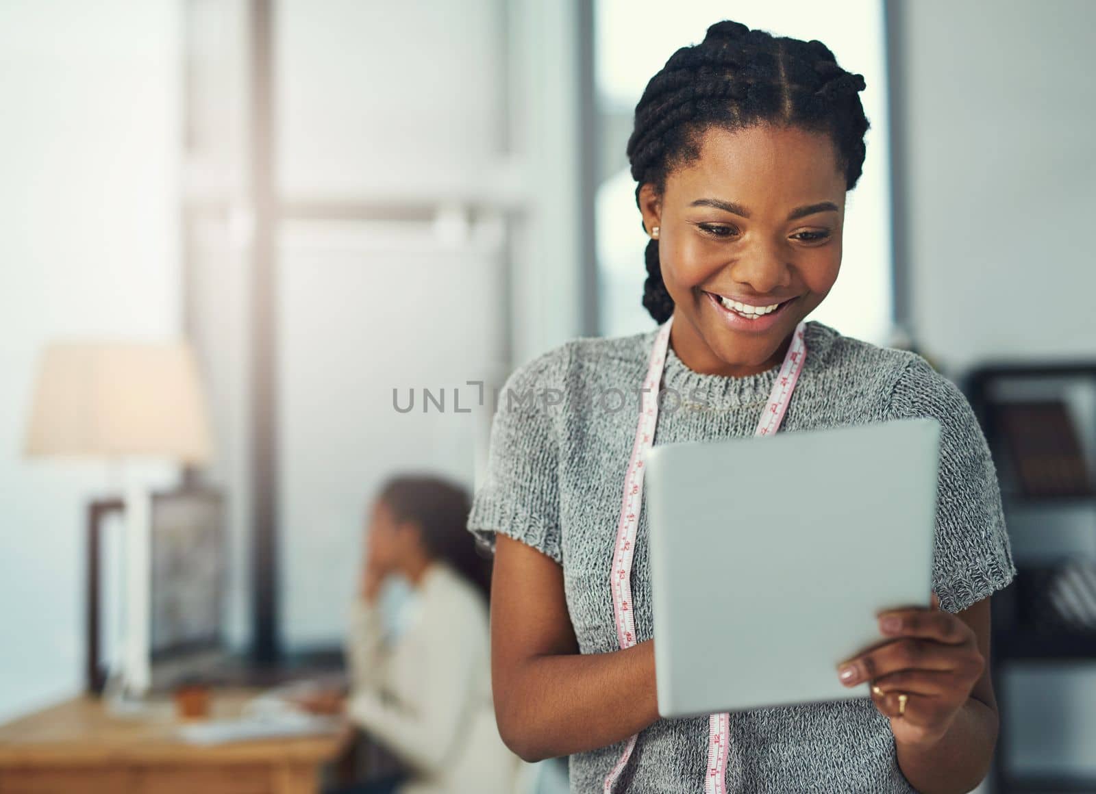 The internet opened a wold of opportunities for entrepreneurs. a fashion designer looking at something on her tablet