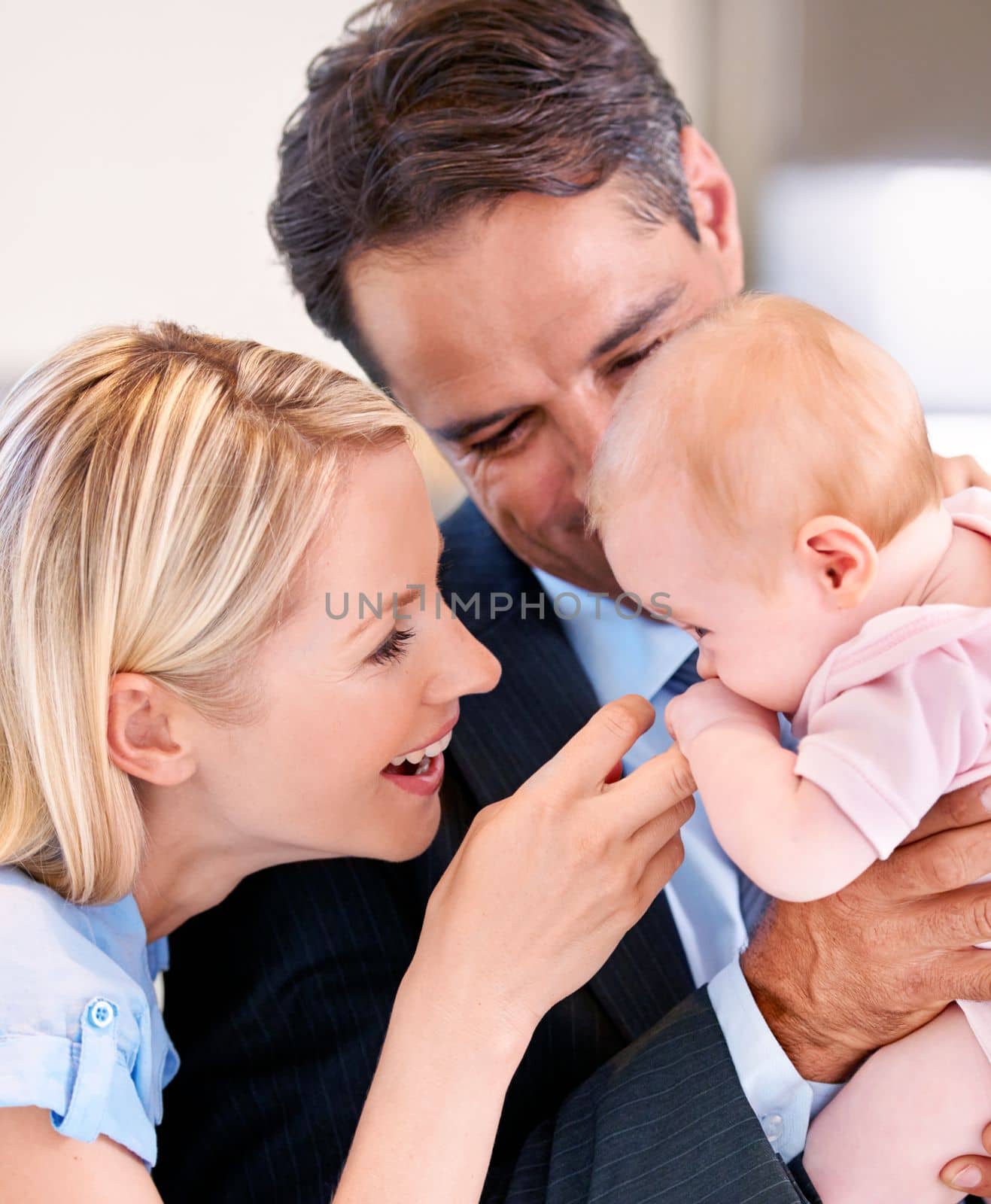 They both love her endlessly. Young couple doting over their cute baby girl