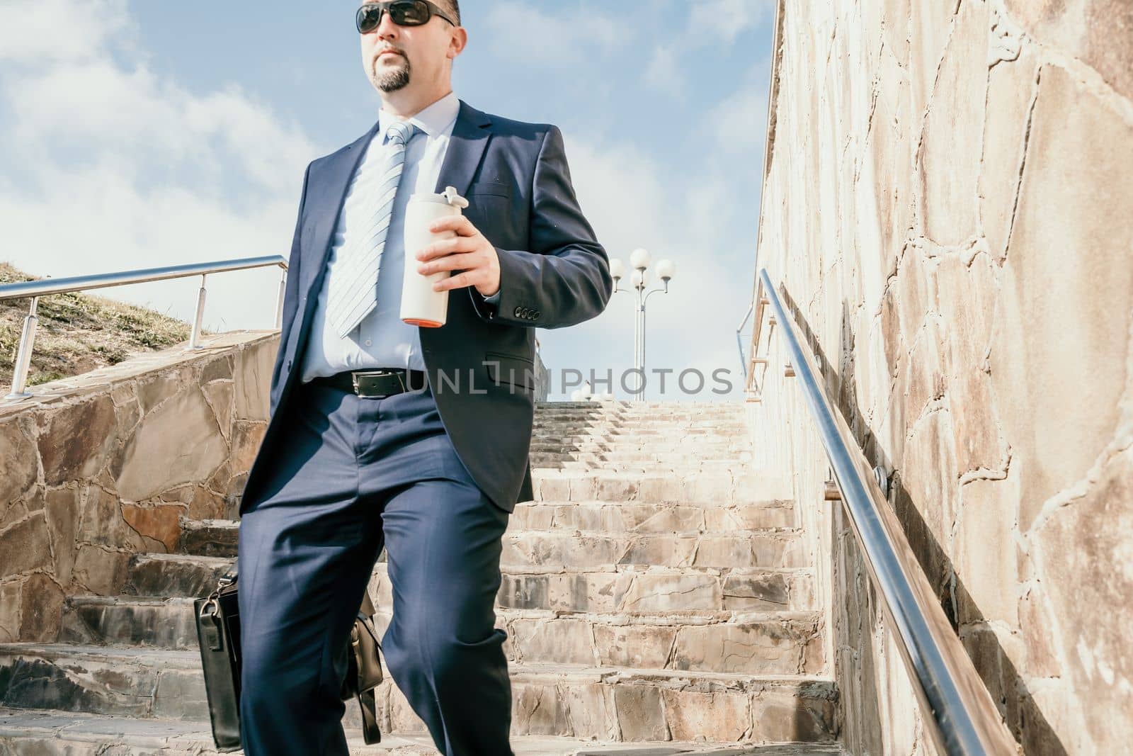 Business executive with briefcase going down the stairs.