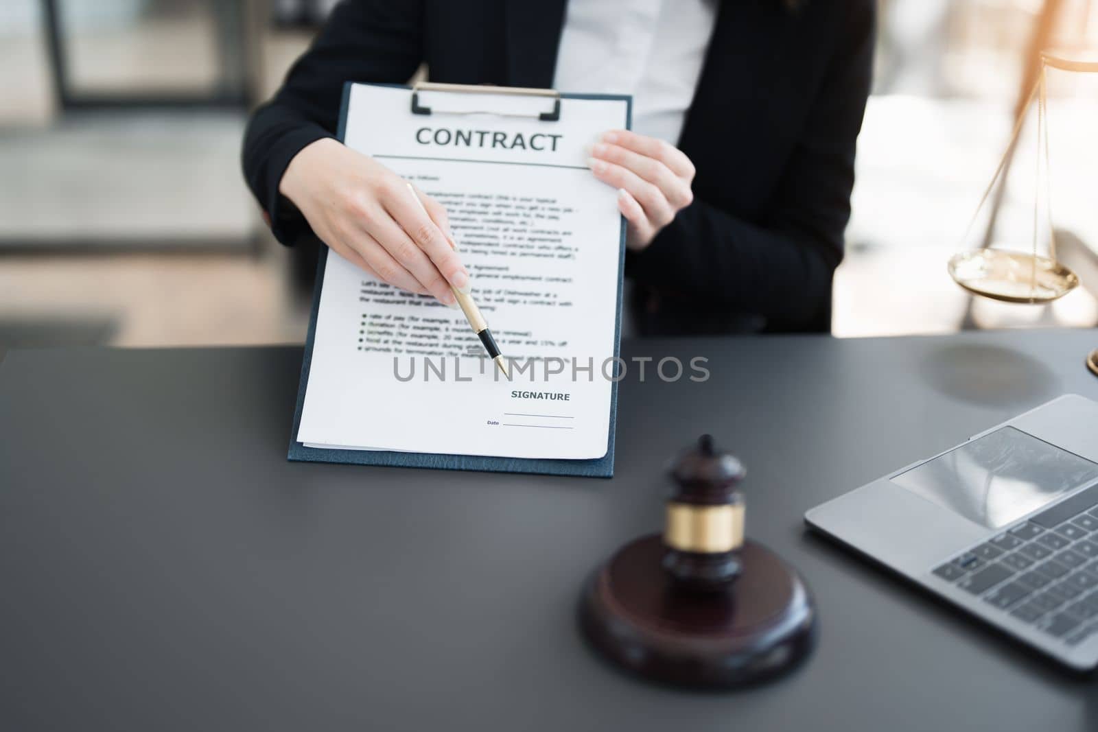 The lawyer with a client discussing contract paper, a Business lawyer working about legal legislation in the courtroom to help their customer, contract and agreement concept. by Manastrong