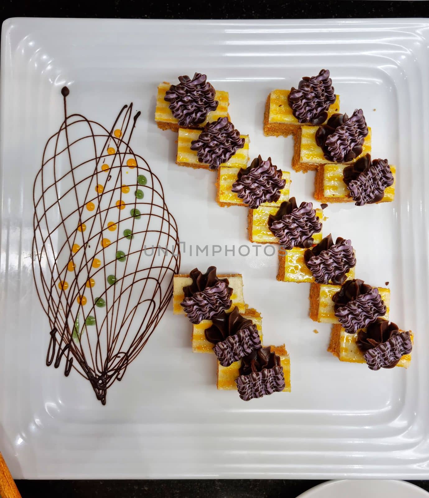 Dessert: delicious cakes on a white ceramic plate. Top view, copy space