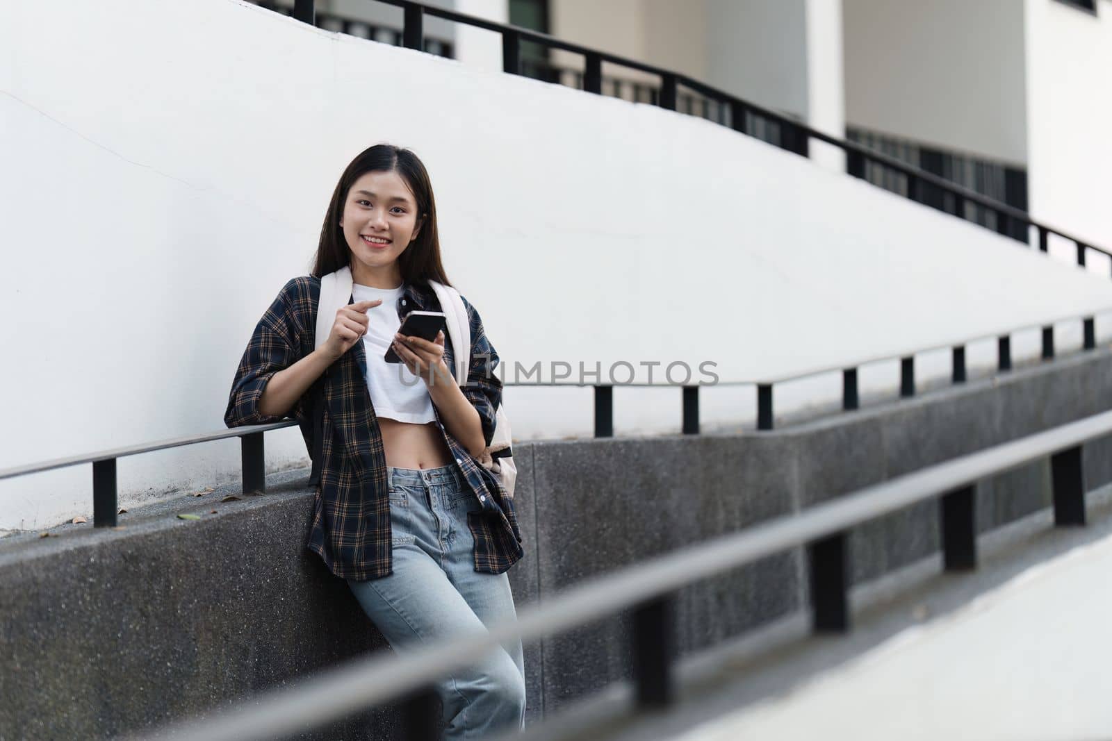 Portrait of beautiful student woman in university ready for learning. Education, scholarship and happy and proud female learner at university by itchaznong