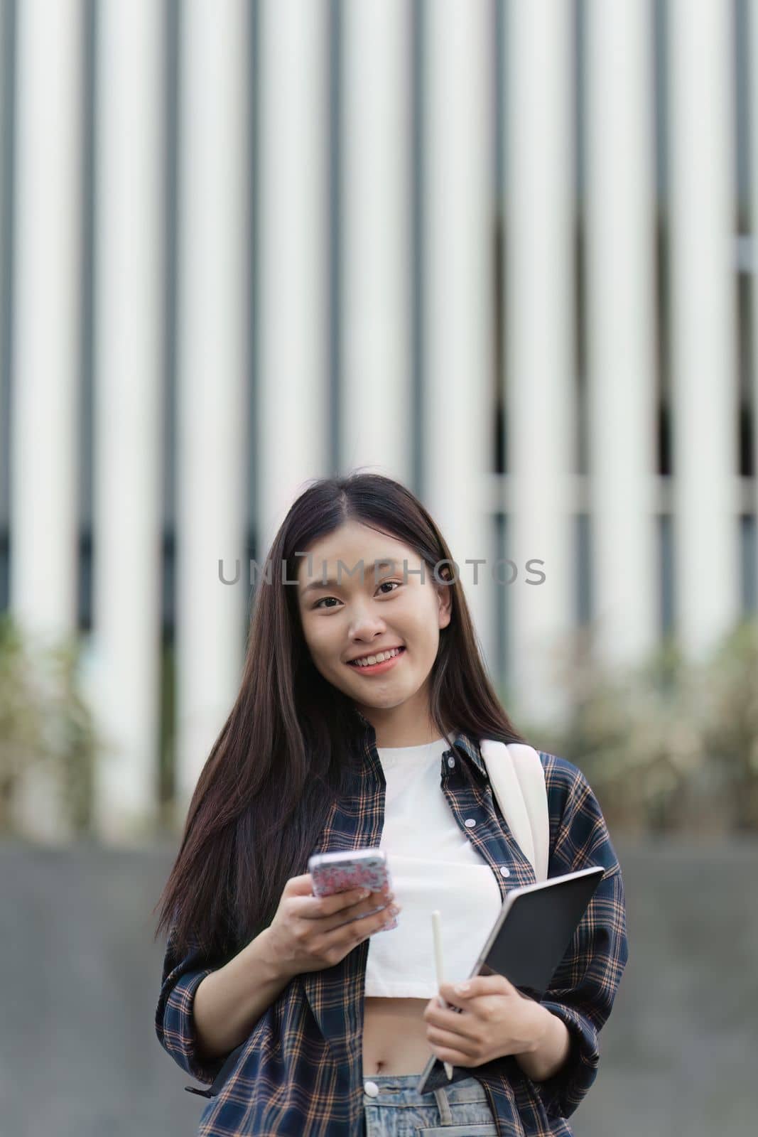 Portrait of beautiful student woman in university ready for learning. Education, scholarship and happy and proud female learner at university by itchaznong