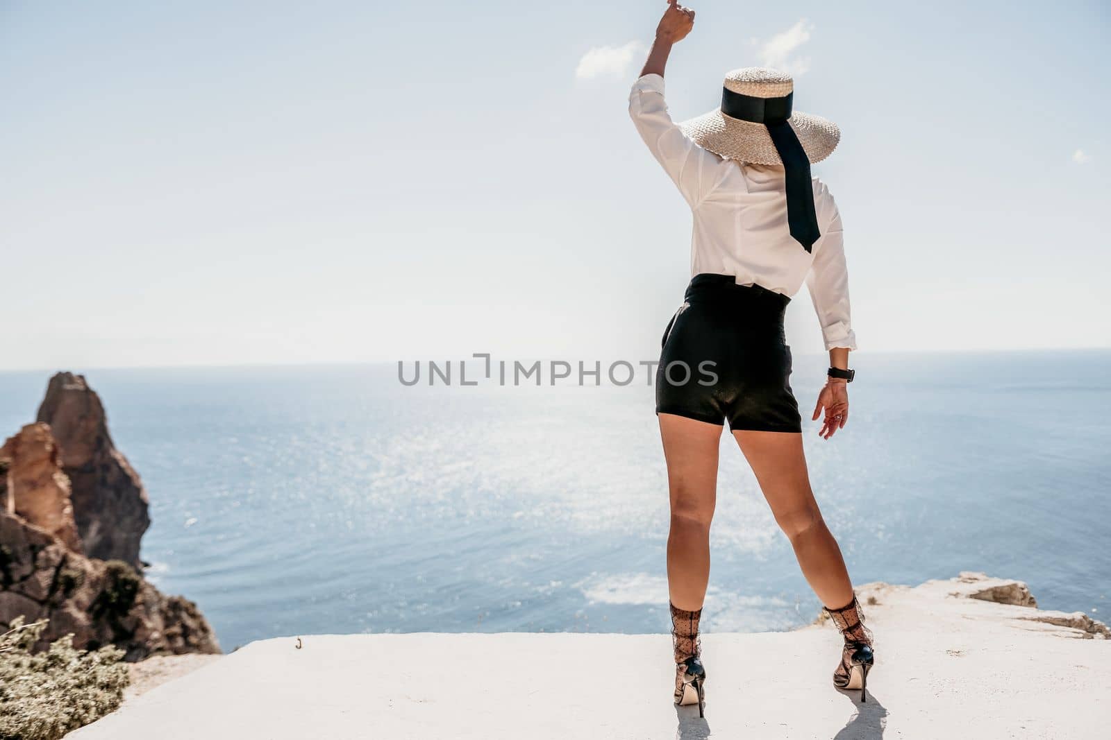 Happy girl doing yoga with laptop working at the beach. beautiful and calm business woman sitting with a laptop in a summer cafe in the lotus position meditating and relaxing. freelance girl remote work beach paradise