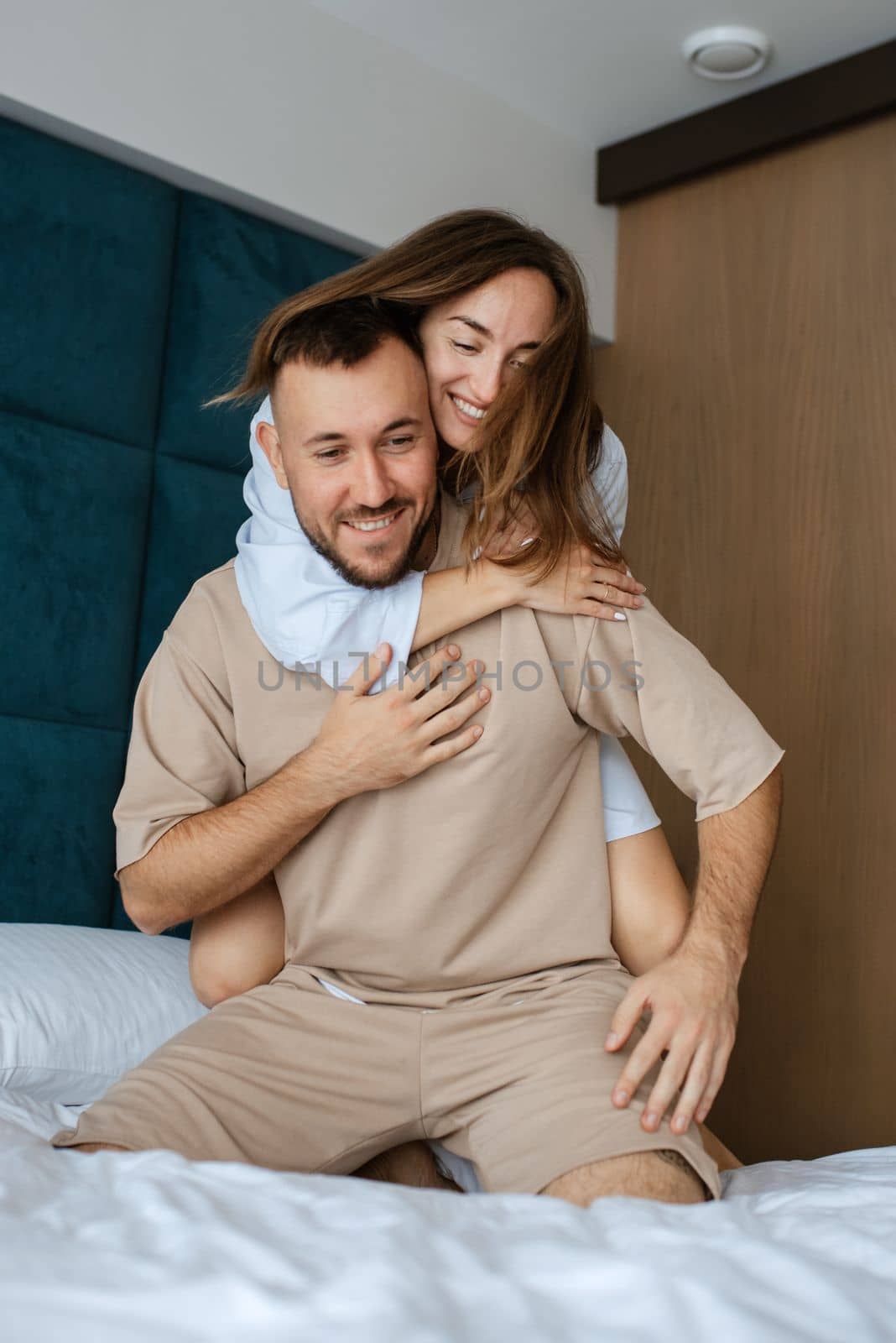 earlier morning bride and groom at home in bed