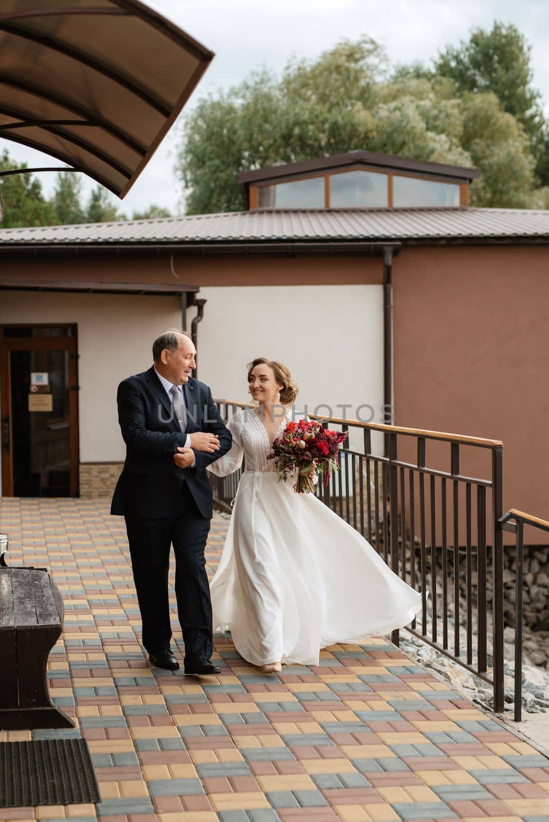 wedding ceremony of the newlyweds on the pier near the restaurant