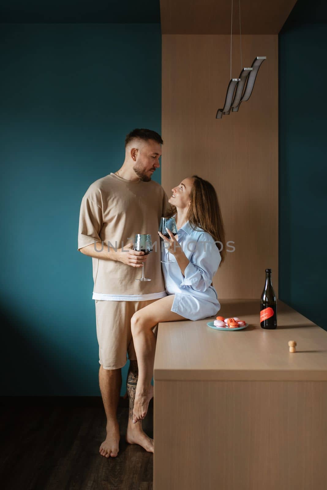 earlier morning the bride and groom at home in the kitchen drinking champagne