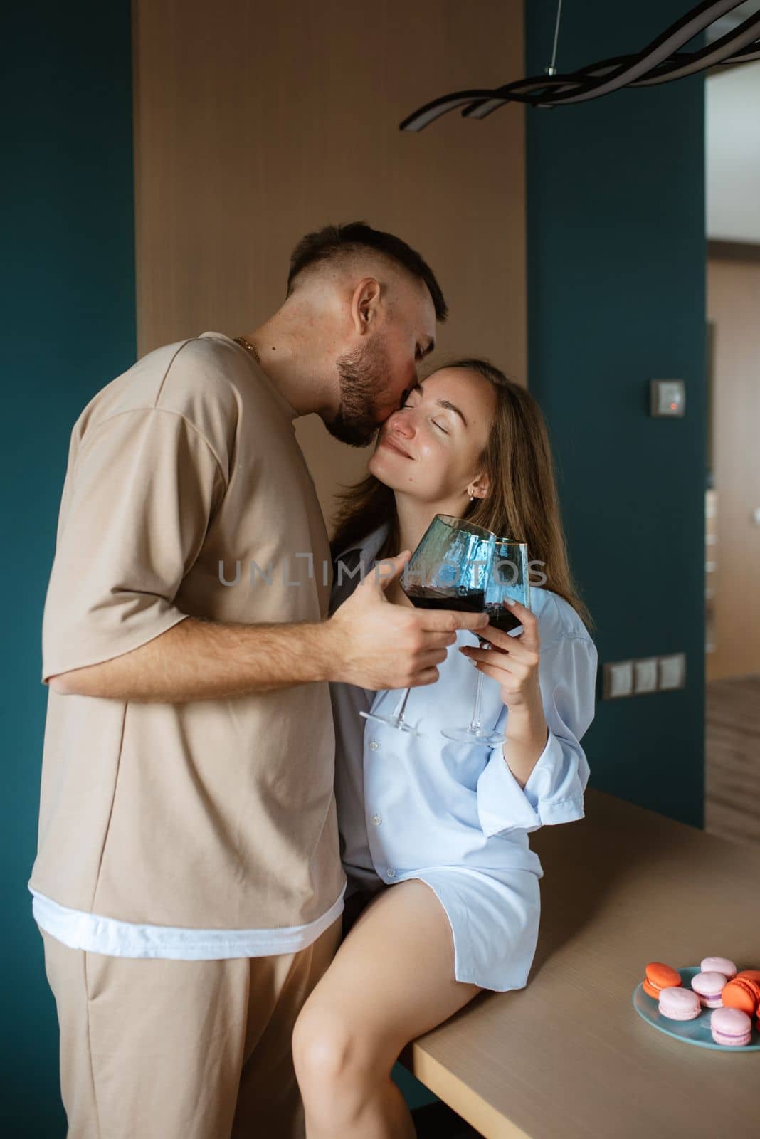 earlier morning the bride and groom at home in the kitchen drinking champagne