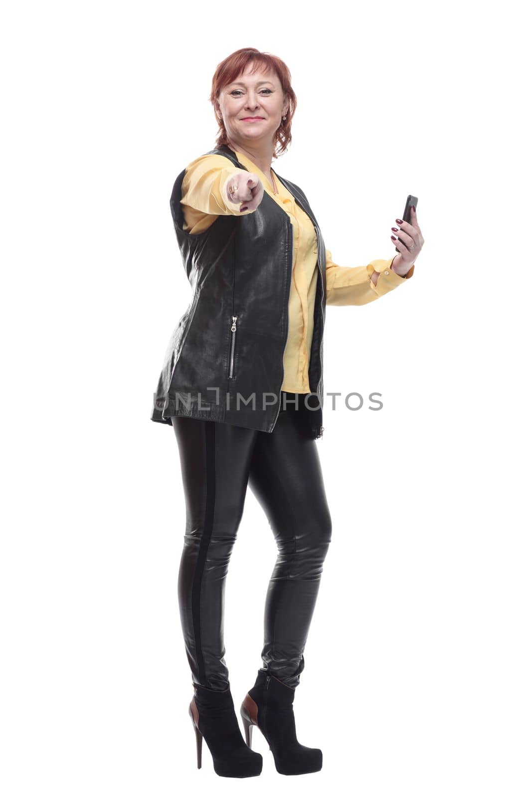 in full growth. happy mature woman with smartphone. isolated on a white background.