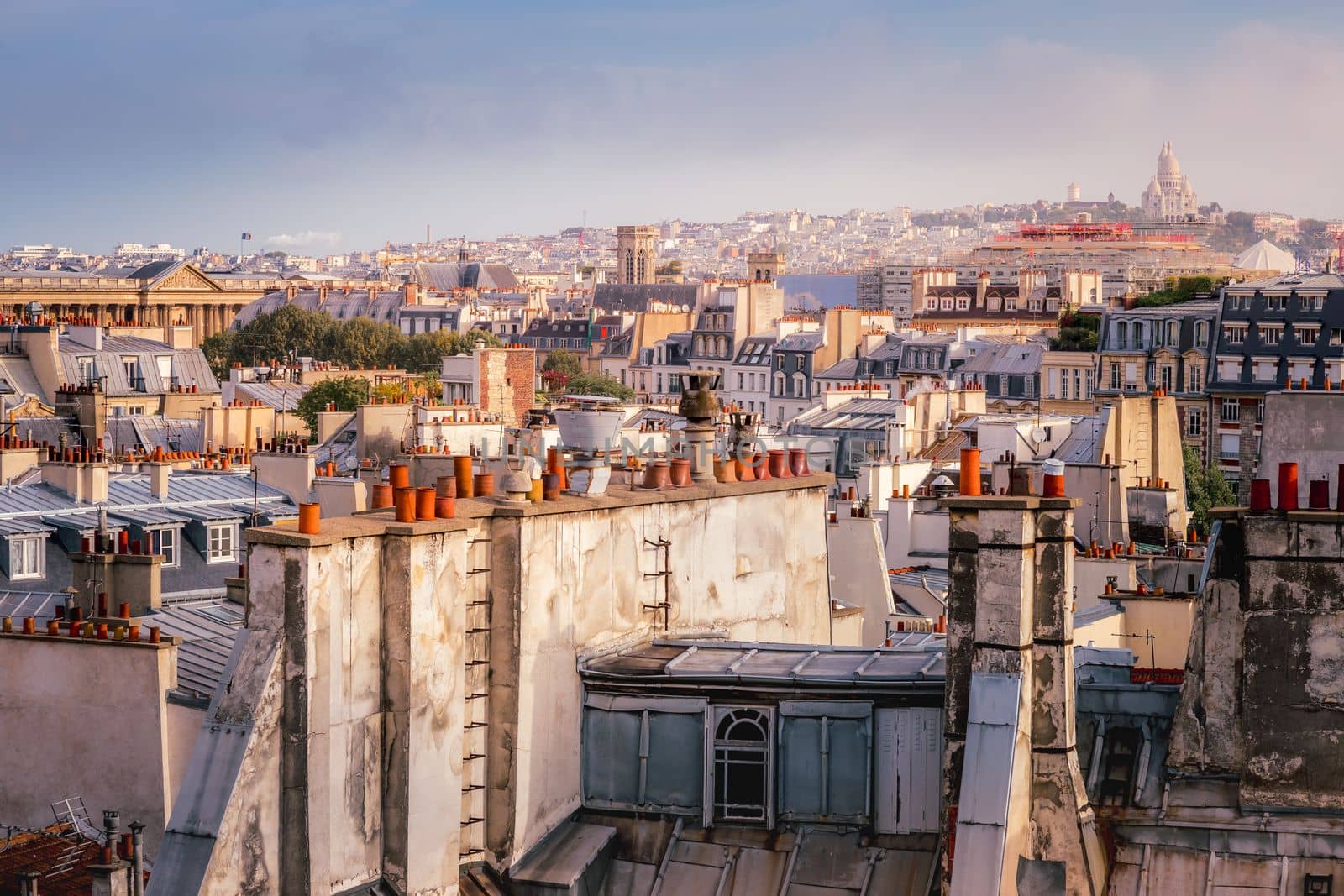 Montmartre and french roofs architecture from above at sunrise from quartier latin, Paris, France