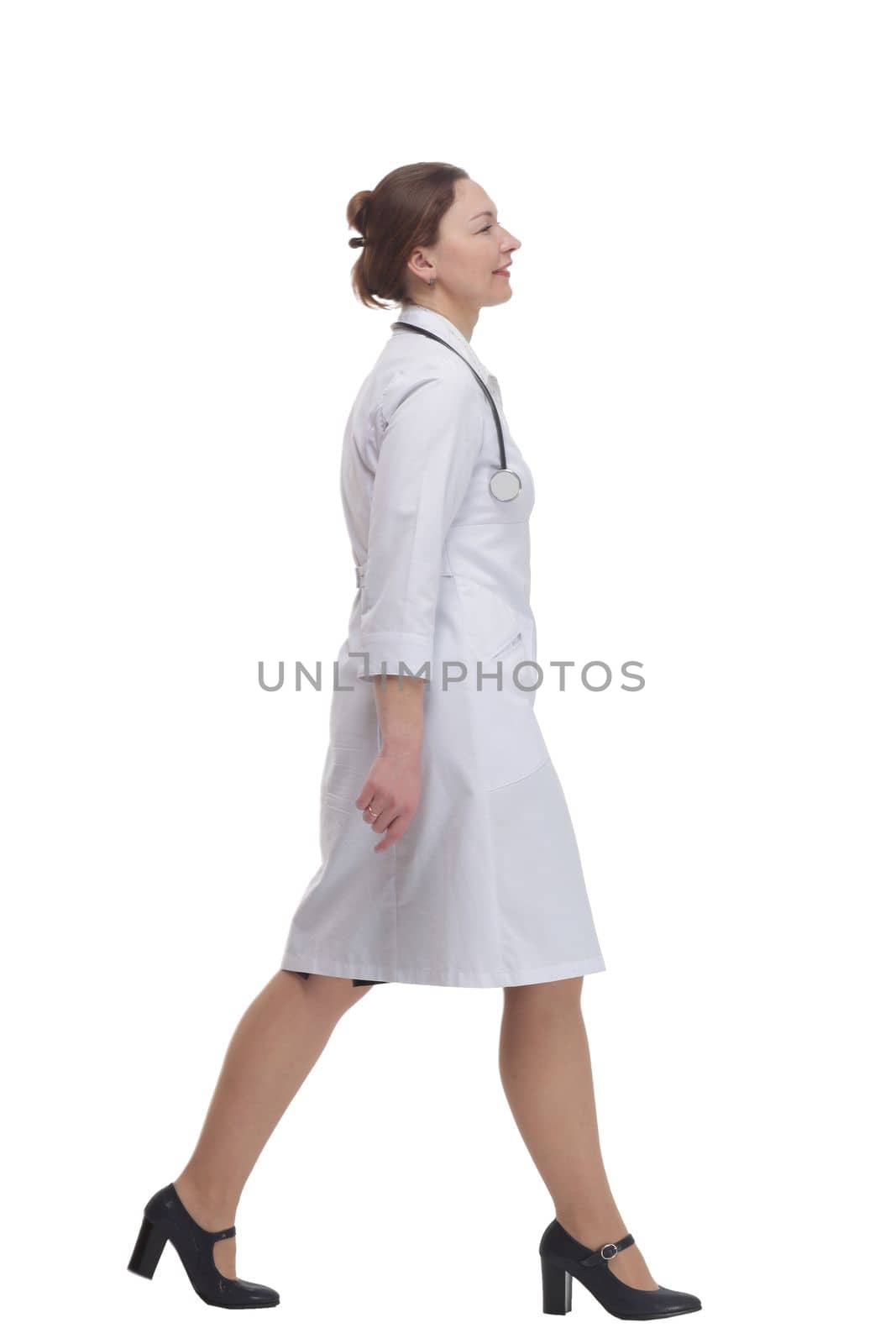 female doctor with a stethoscope striding forward . isolated on a white background.