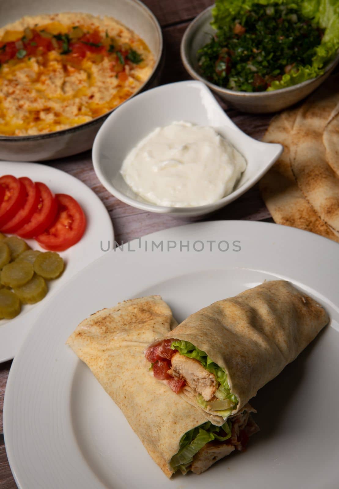 Lebanese recipe of chich taouk, garlic cream, toum, in a Lebanese bread, tabbouleh and chickpea puree, hummus High quality photo