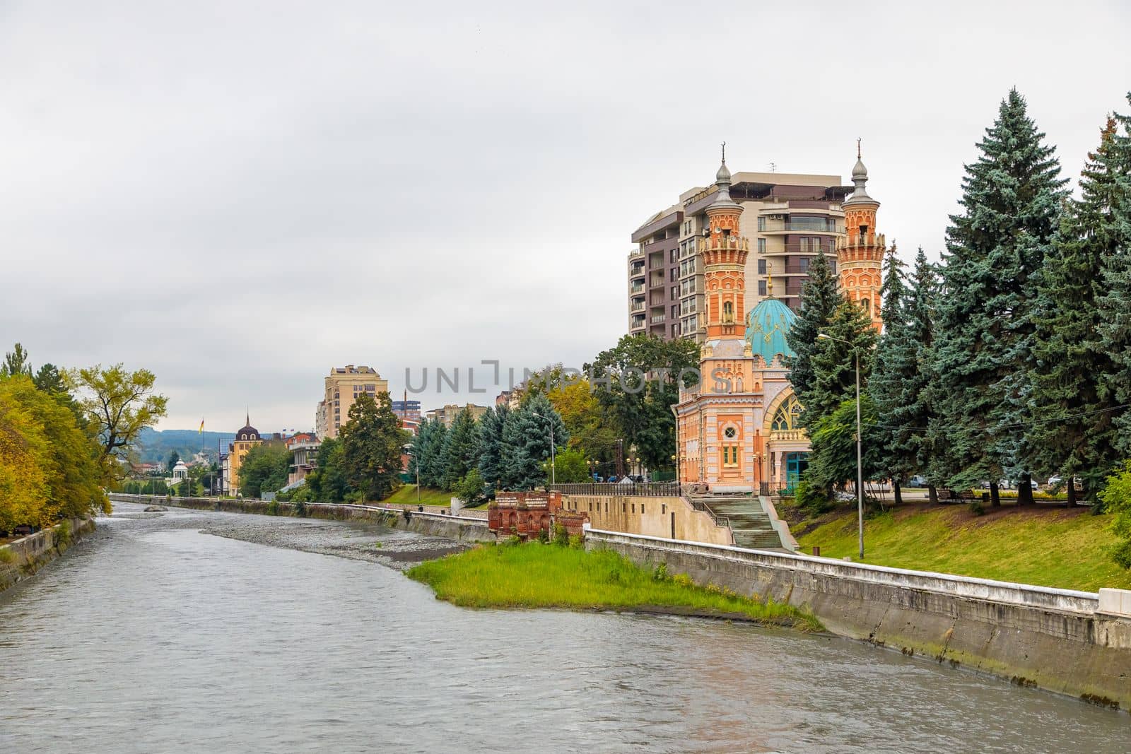 Terek river in Vladikavkaz. Urban landscape. Church and modern buildings