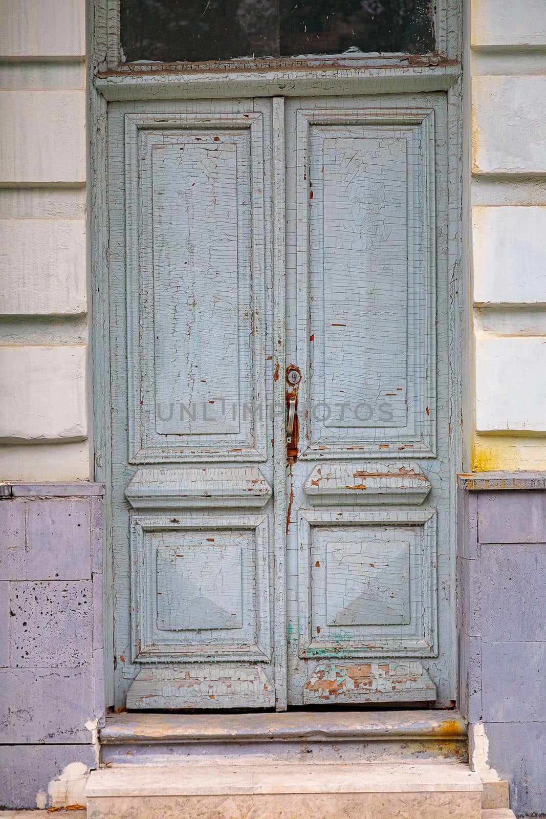 Old cracked blue door in the building