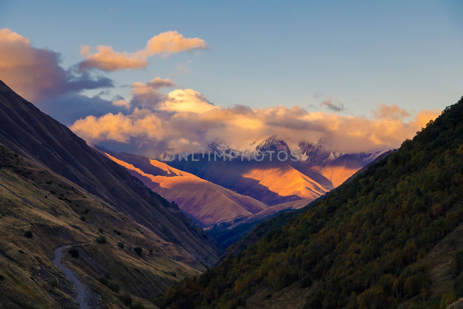 Highlands of North Ossetia. Mountains of the Caucasus. High mountains in the rays of the setting sun. by Yurich32