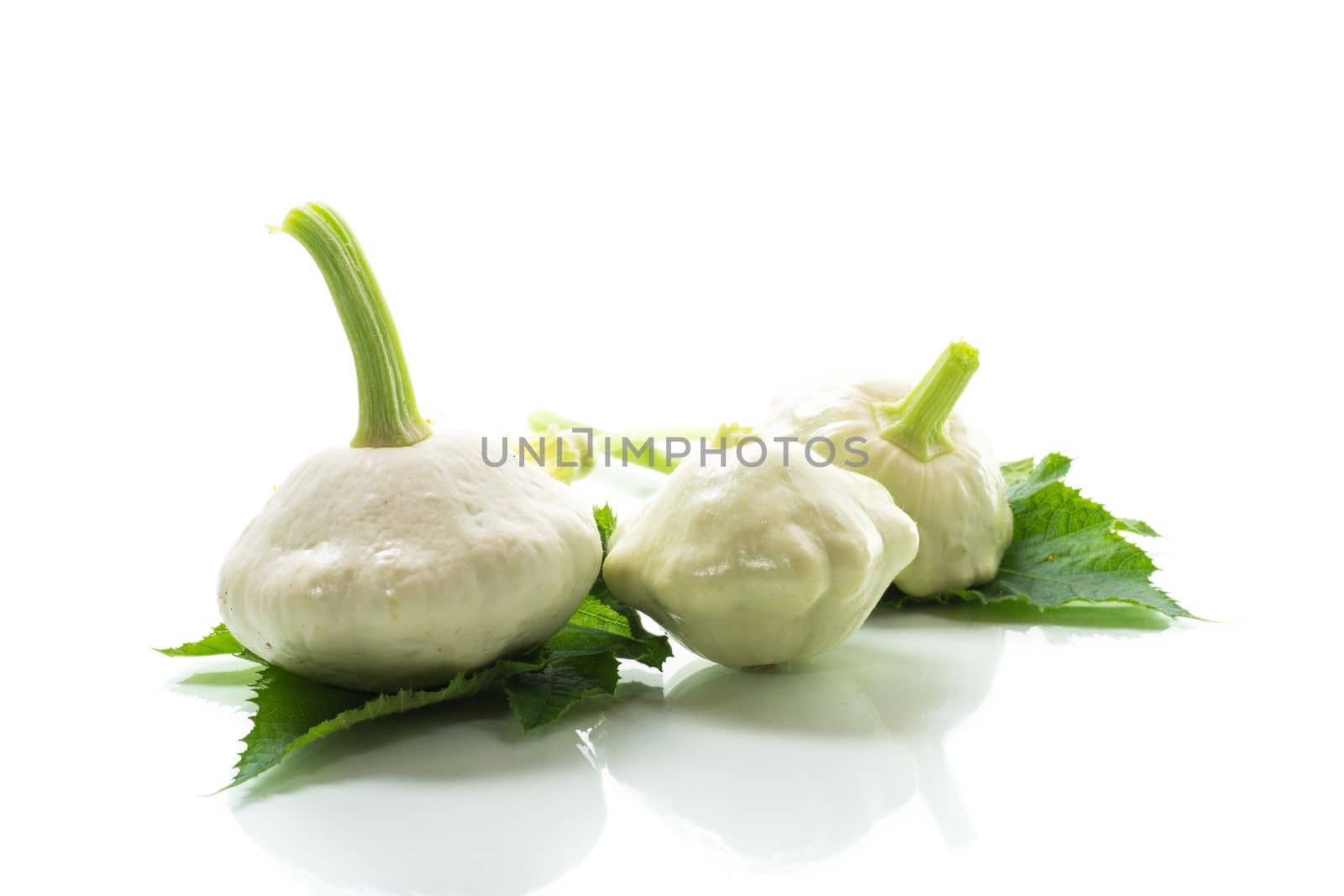 fresh organic squash with flowers and foliage isolated on white background