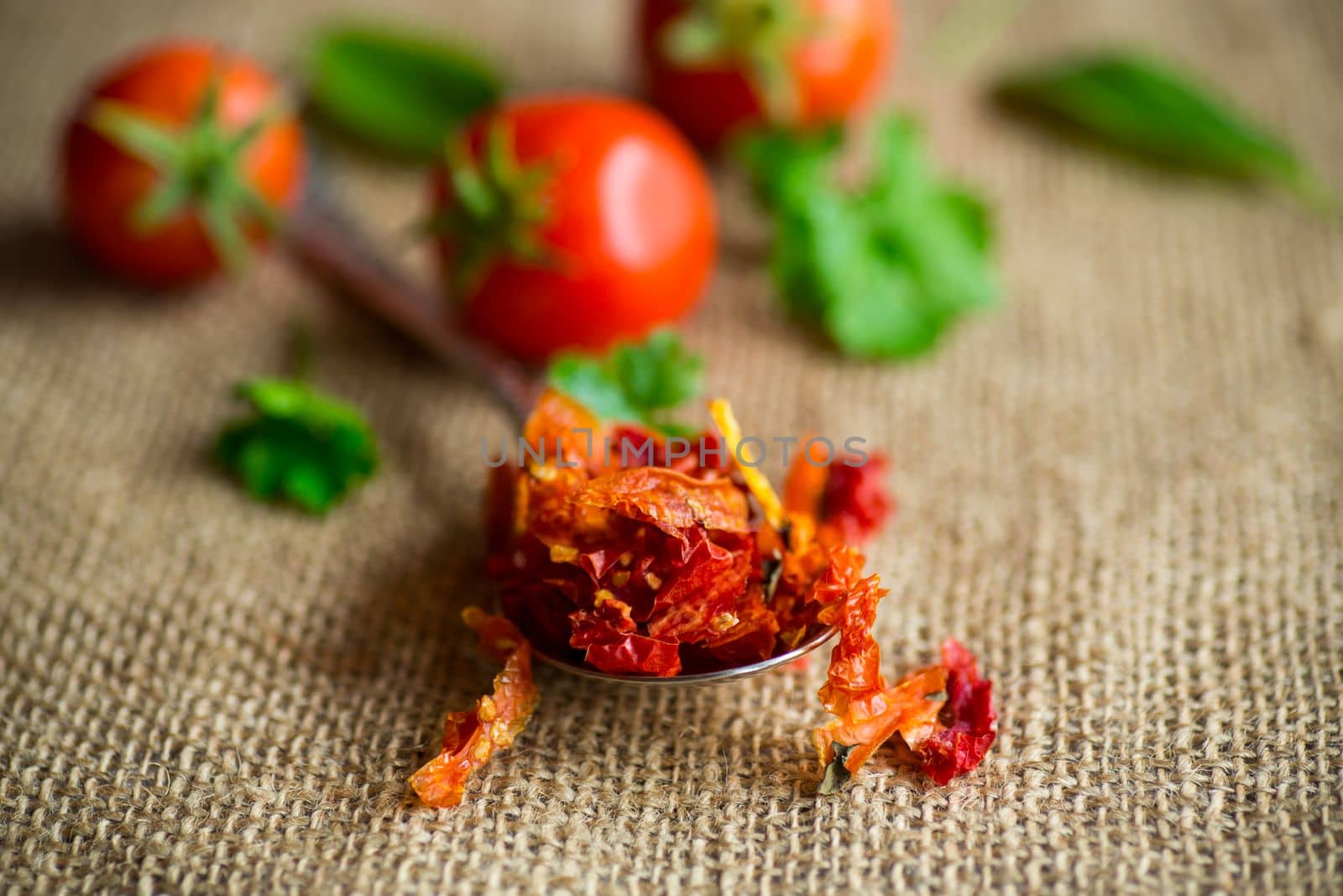 small pieces of dried tomatoes next to fresh tomatoes, natural homemade spices