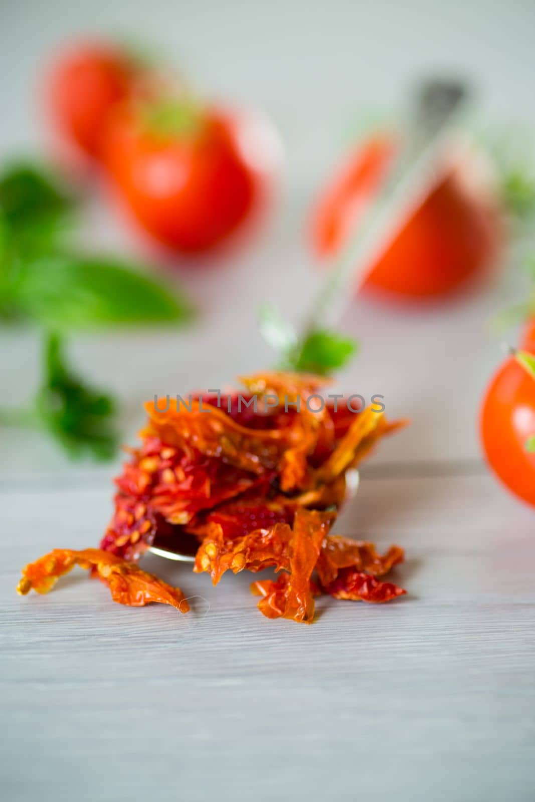 small pieces of dried tomatoes next to fresh tomatoes, natural homemade spices