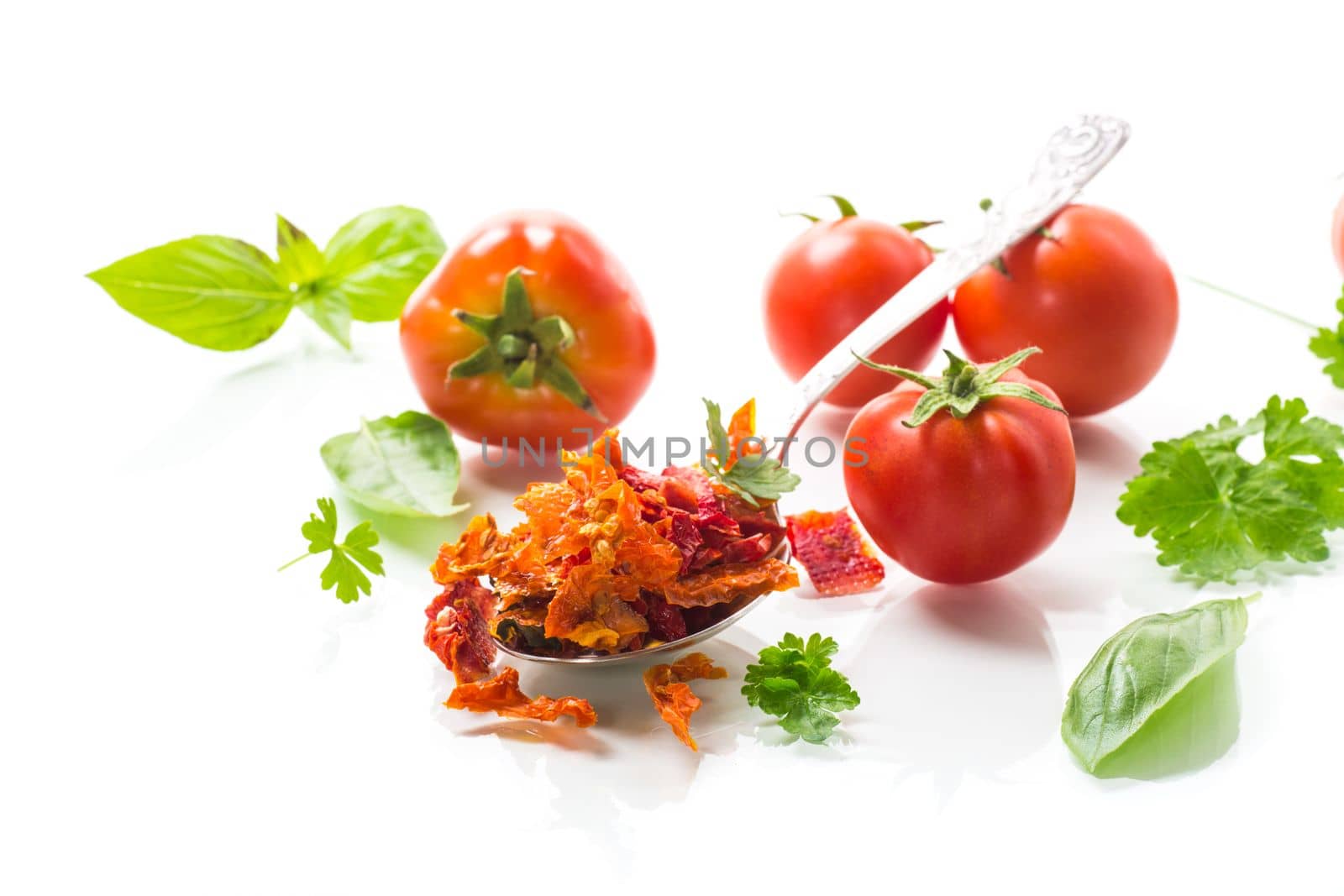 small pieces of dried tomatoes next to fresh tomatoes, natural homemade spices
