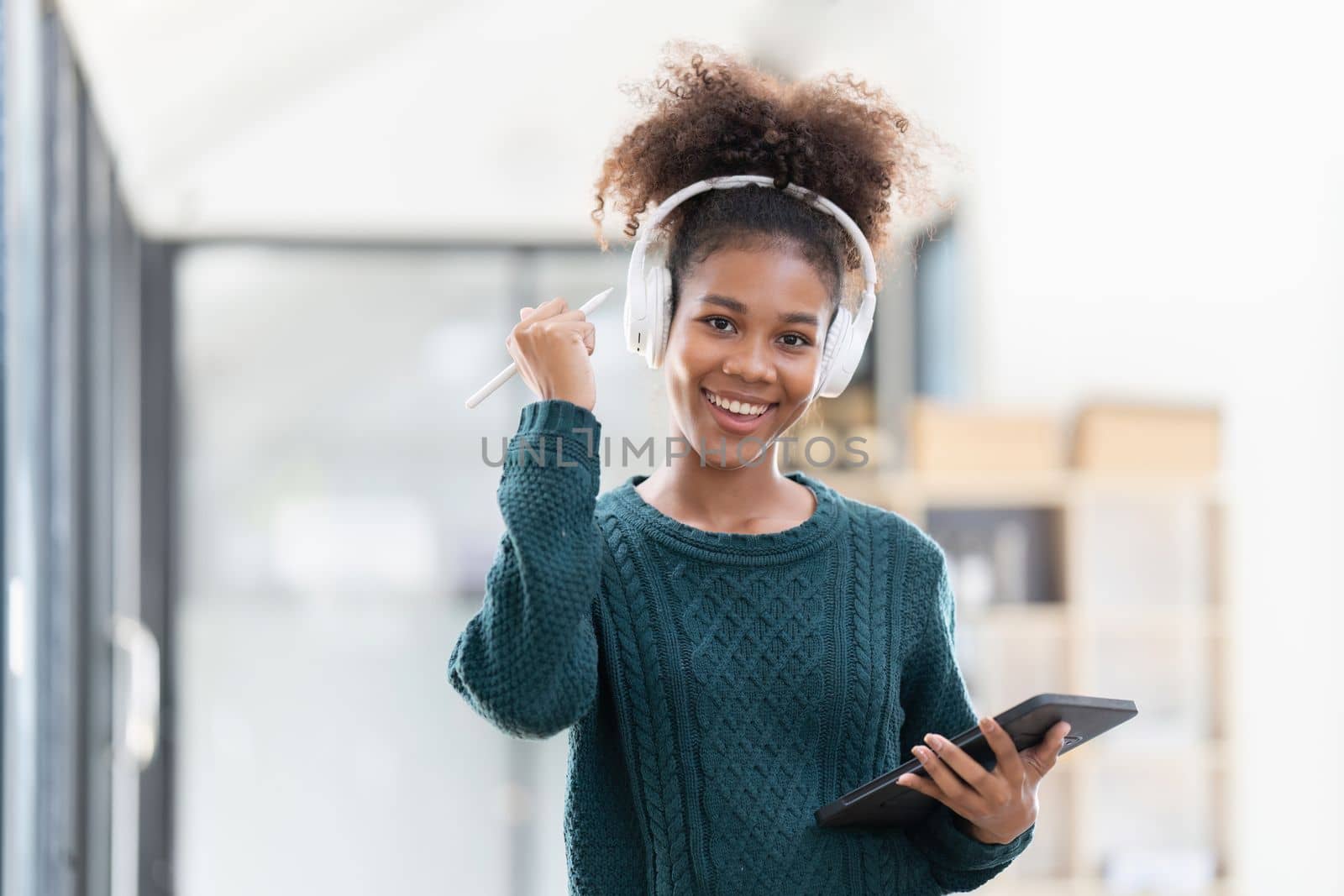 Young woman resting comfortably listening to music at home.