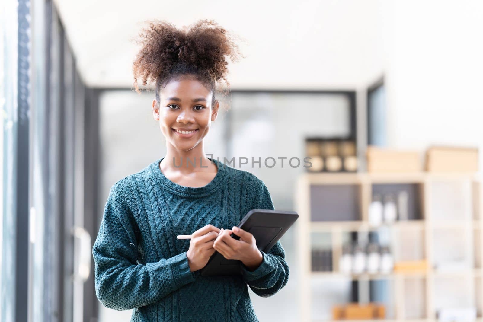 Beautiful young woman working using tablet at home.